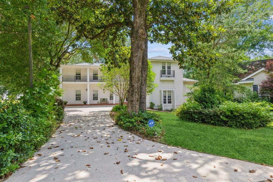 Traditional French architecture with New Orleans influence and incredible views from rear verandas set this home apart from others. Practical floor plan, 10 and 20-foot ceilings and other interior features make it mindful of family living, but one with tasteful style and character. Split bedrooms, 2 living areas (3 including outdoor family room), 2 primary bedroom suites, utility bath at back door and powder room off living room for entertaining, floating open staircase, large walk-in closets, neutral decor of wood tones, greenery and wrought iron are only a few of the appealing features. Over 1200 sqft of covered porches; 560 sqft workshop below grade with double doors for golf cart parking and abundant storage in garage and under rear porch.    See Supplement ...........................