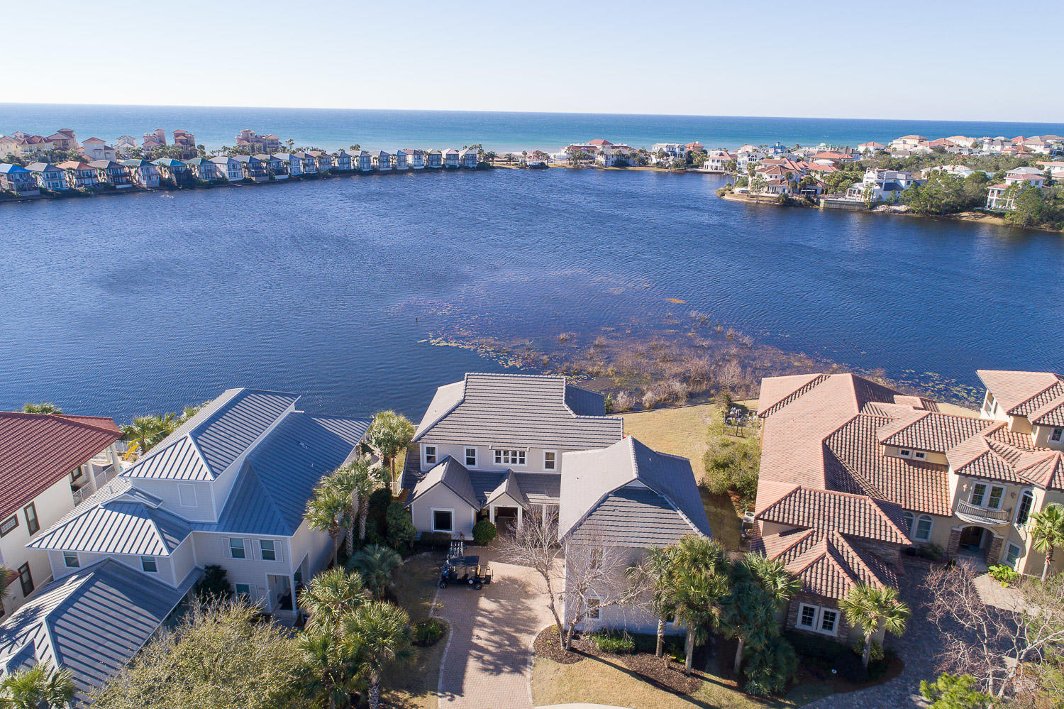 This completely renovated custom built lakefront home with Guest house and gulf views has 7 bedrooms, 5.5 baths, two full kitchens, three laundry areas, and is located on a quiet cul-de-sac in the exclusive gated community of Destiny East. Double sized lot with 110' of lake frontage provides privacy. The main house consists of 5 bedrooms & 3.5 baths with a separate 1000 square foot Carriage House with 2 bedrooms & 2 baths and private entrance. The house was designed to capture lake views from almost every room with expansive outdoor living space and room for a large pool. Recent upgrades include; new kitchen, new appliances, new flooring, new bunk room, two new 3 ton a/c, exterior and interior painted, brand new porch/decking with outdoor kitchen, new Renai hot water heater, new lighting,