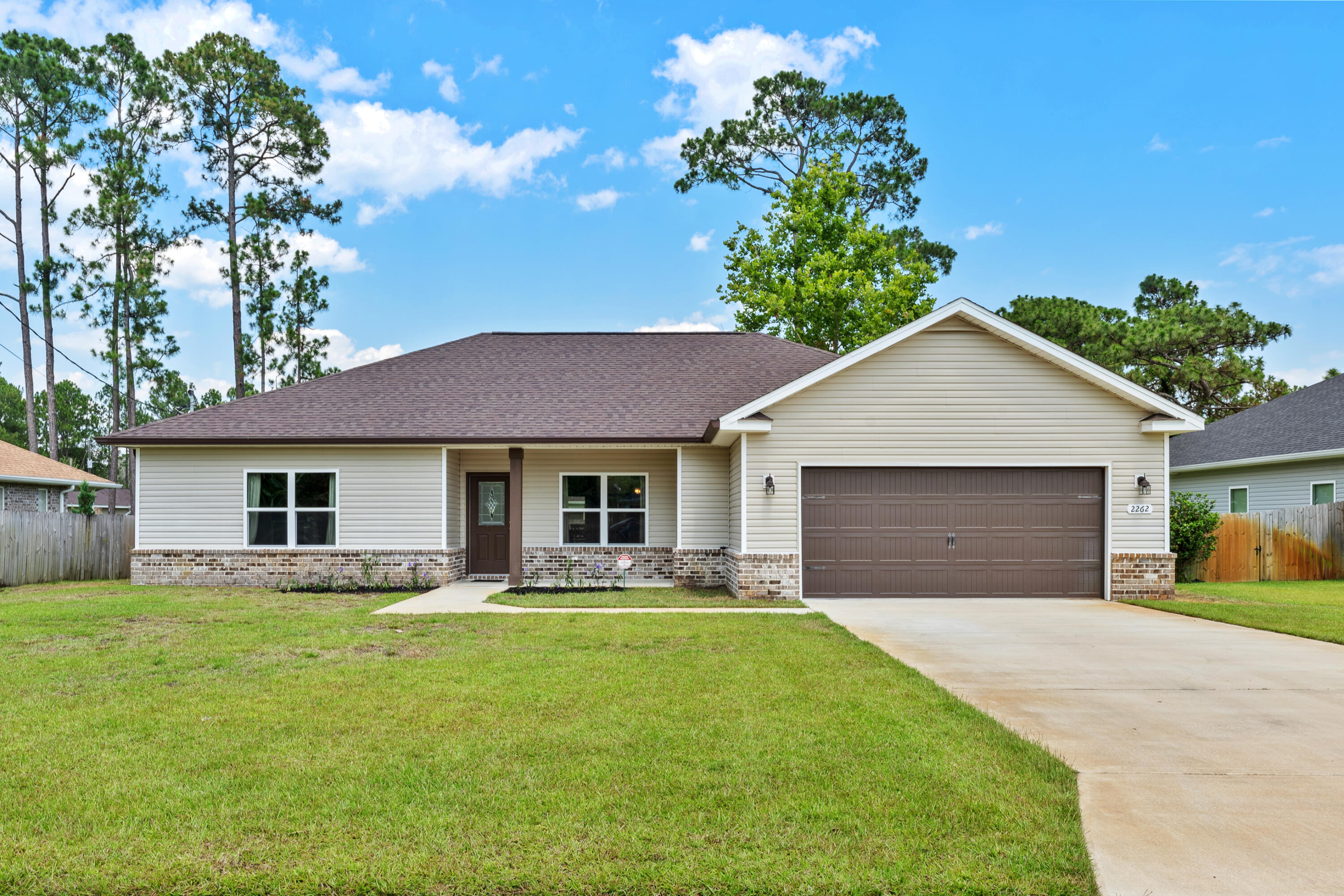 Welcome to Crescent Shores located in East Navarre.  Checkout this Well maintained, open concept, split floor plan 3 bedroom 2 bathroom semi custom home!!!  Brick and vinyl exterior on a large flat, fence lot.   Wood look tile throughout all main living spaces, and carpets in the bedrooms. The Kitchen is equipped with stainless steel appliances, custom cabinets and Granite counter tops and large island.  Owner's suite features beautiful white cabinets and granite counters and access to the back covered patio and huge fenced back yard. Guest bedrooms are both great size with large closets and located just off the hall from the guest bathroom featuring double vanities, granite counter and a large shower/tub.  The home is outfitted with gutters, 2 car garage, lawn irrigation and NO HOA!!!