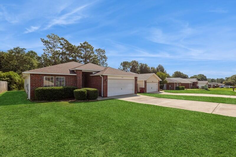 Discover this meticulously maintained contemporary-style home, ideally situated just minutes from shopping, Beaches, Eglin AFB, 77th Special Forces and Duke Field, Hospital, and major highways. This inviting residence features a split bedroom open design, ensuring privacy and space for everyone. As you step through the welcoming entryway, you'll find a spacious coat storage closet.The great room boasts vaulted ceilings, ceiling fans, and a charming plant ledge, seamlessly flowing into the kitchen and dining area. The kitchen is a chef's delight, equipped with sleek stainless-steel appliances, including a smooth top range and dishwasher. The owner's suite is a true retreat, offering a double vanity, a luxurious walk-in tub, a separate shower, a walk-in closet, and elegant tile floors. All wet and living areas feature durable tile flooring, while the bedrooms and living room are comfortably carpeted.

Step outside to the serene backyard, where you'll be greeted by a picturesque view of nature with trees lining the back of the property. While there's no fence, the property extends well beyond the tree line, providing a sense of space and tranquility.

Don't miss the chance to make this beautiful home yours!
