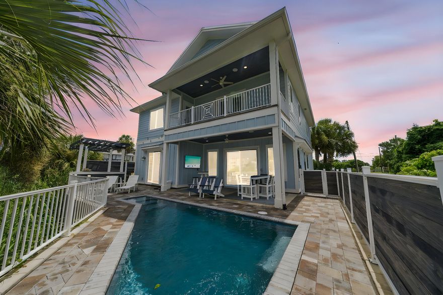 This STUNNING custom built beach home offers breathtaking lakefront views and bedroom views of the Gulf, with 5 bedrooms, 4 full bathrooms, and an incredible outdoor space featuring a private pool, summer kitchen, and built-in sound system. There is an adjoining lot next door is available if desired (not listed) and could be sold as a separate purchase with negotiated terms, only available with the purchase of this property. Inside, you'll find a designer kitchen for entertaining, with custom cabinetry, stainless appliances, and a wine bar. The open-concept living area flows to the outdoor oasis, perfect for relaxing or entertaining. A first-floor guest suite and custom bunk room are ideal for hosting family or maximizing rental income. Upstairs, the Primary Suite and second king bedroom both open to a large balcony with both Gulf AND lake views. Additional guest rooms offer en suites or nearby baths, and a second living area includes a queen sleeper and 75'' TV. This home is turnkey and packed with upgradesfrom a Sonos audio system to custom tile work throughout. Whether you're looking for a personal getaway or high-income rental investment property, this home delivers luxury and lifestyle in one.