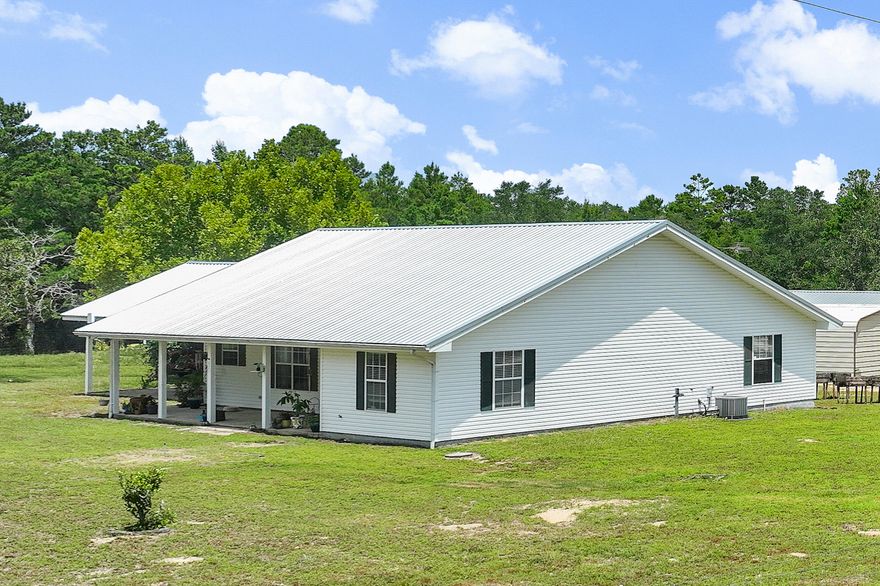 Beautifully Updated Home on 4.5 Acres!This peaceful 4.5-acre property offers the perfect blend of privacy, comfort, and functionality. The open-concept home features two spacious primary suites, an extra large front porch, and a newly renovated kitchen with quartz countertops, custom tile work, floating shelves, new appliances, and updated lighting. A separate suite with a kitchenette, gas range, commercial vent hood, and built-in grill provides flexible living or guest space.Outdoors, enjoy: Outdoors, enjoy: 
- 2+ acres of mature trees with a walking trail
- 2+ acres of fully fenced pasture divided into 3 sections ideal for livestock or gardening
- Stables and chicken coop
- 24x60 barn/workshop with power
- 18x25 insulated storage building with power
- Full RV hookups and separate septic system
- Private well + public water access (meter in place, tap fee required)

Attached covered parking and wide-open skies complete the picture. Just 25 miles from the white sand beaches of Destin, 20 miles to Niceville, 15 miles to Crestview, and 10 miles to downtown Defuniak Springs. "Finca del Sol", Ranch of the Sun, is a rare opportunity to own a move-in ready homestead with room to grow.