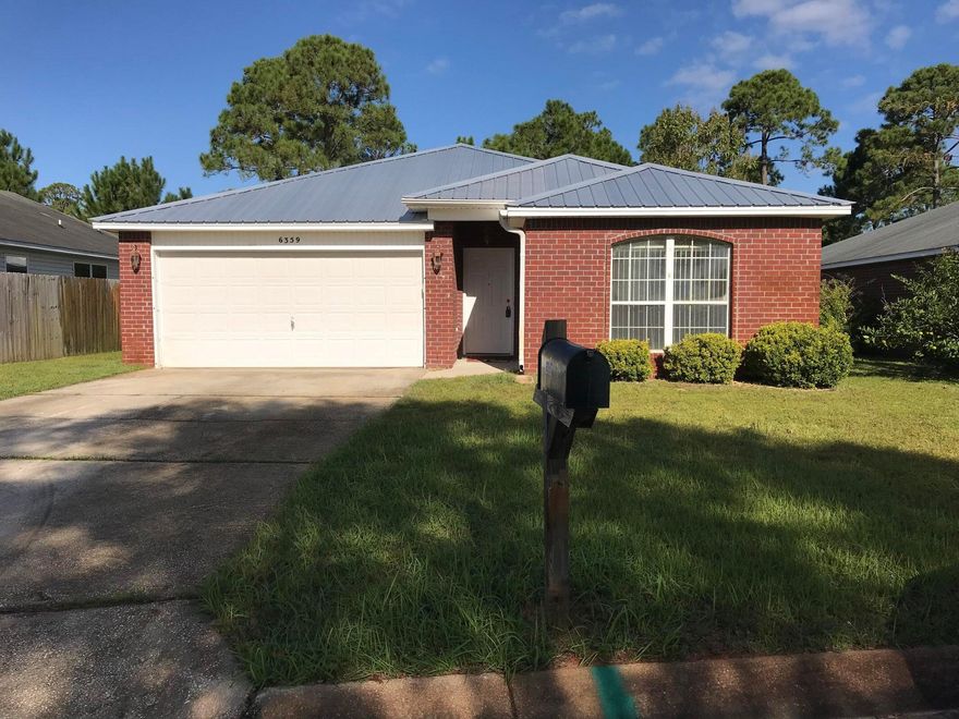 Hidden Shores Community home now available! Conveniently located in the Midway-Gulf Breeze area, the location makes for a quick commute to Hurlburt Field or Pensacola. This 3-bedroom, 2-bathroom brick home is perfectly situated on a desirable exterior lot, with natural Florida landscaping in the backyard, and wooded private green space beyond. The interior has a large main living area with an open concept floor plan, and low maintenance ceramic tile. The kitchen features a large pantry, island, ample cabinets and counterspace, as well as a separate dining room. The living room has a great view of the backyard, plenty of room for extra-large furniture and includes a wood burning fireplace. The master suite has 2 walk-in closets, a double vanity, linen closet and an oversized tub/shower.