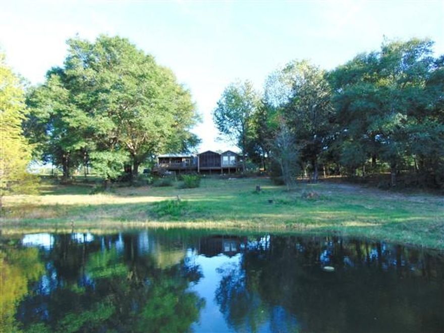 If you're looking for acreage w/ water, pastures for your horses & plenty of storage..look no further..this is the one! This rustic 2543 SF cedar home (4260 SF under roof) sits on a beautiful 20 ac lot. Property is fenced & cross-fenced w/ 2 electronic gates coming in & several pastures. There is a spring fed pond fed by numerous springs running through the property. 4800 SF metal barn w/ penned area for horses & plenty of room for all your farm equipment. The home is a dream w/ beautiful wood floors, walls & ceilings; 3 BR, 3 ba; Fireplace; Open kitchen, dining & living room; screened porches, open decks...& all overlooking the pond & beautiful rolling hills of this one of a kind property. CenturyLink high speed internet available. 2015 pty taxes just $554.81. Don't miss out on this one!