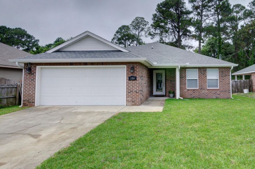 Welcome home to this move in ready 3 bed/2 bath brick beauty just minutes to Hurlburt's front gate! Drive up and start by appreciate the brand new landscaped yard (new sod in the front and backyard), and walk up to the beautiful glass front door. Inside you'll find ceramic tile throughout (carpet is only in the 2 guest bedrooms), and freshly painted walls! The long entryway leads to a split floor plan where to the right you'll find two nice sized guest bedrooms with a shared bathroom. The open floor plan features a large living room with crown molding and recessed lighting which leads to the eat in kitchen space and then the well appointed kitchen. Showcasing custom cabinets, granite counters, stainless appliances, a separate pantry, crown molding, and drop down pendant lighting over the