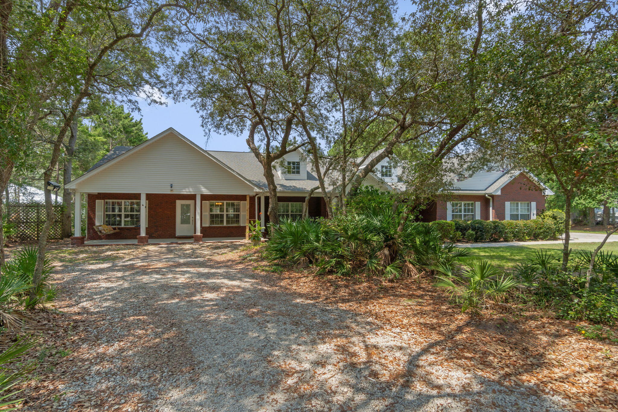 Rare opportunity to own a home in Bluewater Bay area Niceville! Private,level 1.24 acre lot, 1-story home, in-law (or income producing) 1200 sq ft suite! Total 5 bedrms, 3 full & 2 half baths. In-law suite has own entrance or use door between main house & in-law suite to combine sides. In-law suite: 1200 sq ft (living, 1/2 bath, dining, huge kitchen w/granite, large master & bath). Main house: 4 bedrm, 2.5 baths, large bedrms, great rm, kitchen w/granite-stainless steel appliances-gas cooktop, 2 car garage (1/2 finished but can be re-opened). Property offers: privacy, fenced backyard, Heated/cooled storage (could be finished for living unit), extremely large workshop (RV garage),Boat/RV covered parking, & much more. Buyer to verify all deemed important inf. UNDER CONTRACT-Acc. BACK UP OFF
