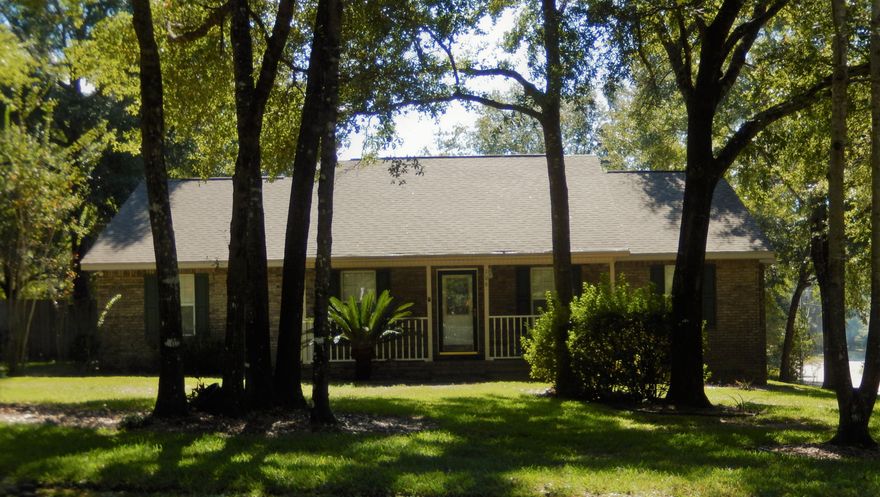 Better than new home has come available in coveted Indian Trails Subdivision. Beautiful all brick home situated on 2/3 acre wooded lot. This custom-built home is situated on a rare 3 street frontage creating a feeling of privacy. Mature oak trees provide a cooling breeze on those warm summer days. Sprinkler system provides a lush St. Augustine lawn. This open floor plan features a spacious sized Living Room with a gas fireplace. Dining room with new brushed nickel chandelierand arched doorways to enhance Breakfast Area and Kitchen which has beautiful all custom wood cabinets with lots of storage, indirect lighting (rope lights on top of cabinets) generates a soft glow in the evenings and plenty of counter space. Brand new carpeting in the Living room, Dining room and Bedrooms.