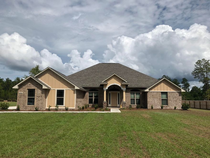 Under construction: Enjoy a large and spacious 3011sqft plan with a 3-car garage on a deep 1-acre lot: this beautiful home favors large bedrooms and an expansive Great Room, perfect for the growing family! A wide Florida room overlooks the back patio: this is a favored room for backyard activities or a future pool. The kitchen features a wraparound bar with granite countertops, abundant custom-made maple cabinets, recessed and undermount lighting, and a large walk-in pantry. This home is energy efficient with a 14 seer HVAC and low-E vinyl windows; stainless steel appliances give it a modern touch, and the stacked-stone column bases give it great curb appeal. Nichols Creek has easy access to I-10, and the sugar-sand beaches of Navarre are less than a 30-minute drive away!