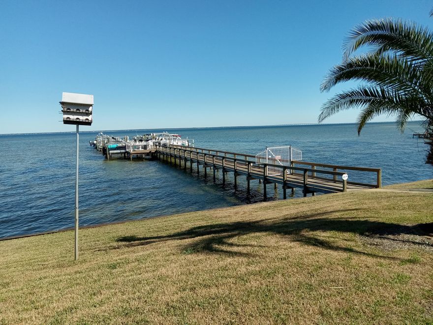 Convenient 1st floor location on the Bay at Century Park in Destin. Century Park offers bayfront living and amenenities within a desirable Destin location. The huge waterfront pool, community room and bayfront dock offer residents recreational opportunities and sweeping views of Choctawhatchee Bay. This comfortable 1 bed/1 bath has a convenient location (middle building, end unit, first floor) with parking just outside the front door. The interior was last updated 12-15 years ago, including floors, cabinets, appliances and countertops. Unique features in unit # 111 are a 4 x 8 bonus area (bunk area, office area or reading nook) adjacent to the kitchen and an enclosed patio / Florida room overlooking the pool and Choctawhatchee Bay.