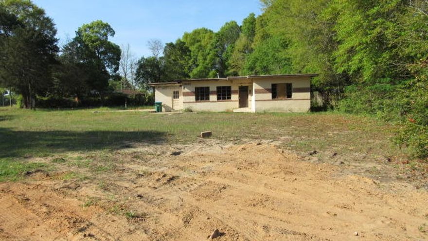 Looking for a project? This block style home is ready for your makeover. The owner has partially gutted the interior .Or this .47 AC parcel could be split to build 2 homes.SOLD AS IS