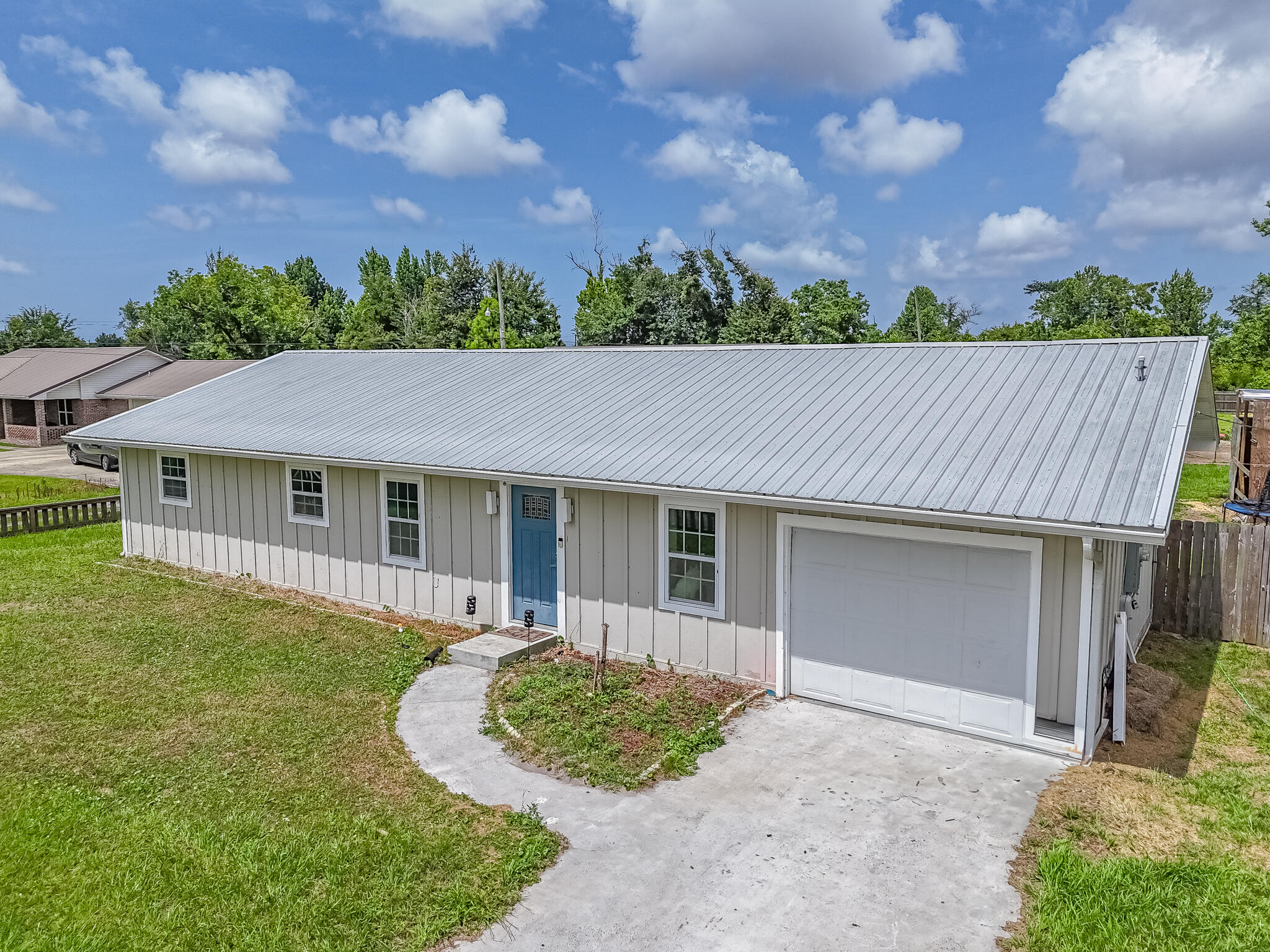 Spacious and updated describe this property! 5-bed, 3-bath home sits on a 0.69-acre lot with a huge backyard area. Home features a metal roof, HVAC, and water heater all new in 2022 (effective year built: 2018). Inside, luxury vinyl plank flooring and LED recessed lighting create a bright, open feel. The split layout includes two oversized bedroom suites, ideal for multi-generational living. The kitchen is a showstopper with shaker cabinets, quartz countertops, tile backsplash, stainless appliances, and modern lighting. A sliding barn door adds style to the spacious laundry room. The fully fenced backyard includes a 2023-built barn--perfect for storage, hobbies, or even farm animals. Just 5 minutes from John B. Gore Park, enjoy easy access to boating and fishing. Location central to ample shopping and amenities of the area. Located only a 13 minute drive from Tyndall AFB. A rare blend of comfort, function, and location!