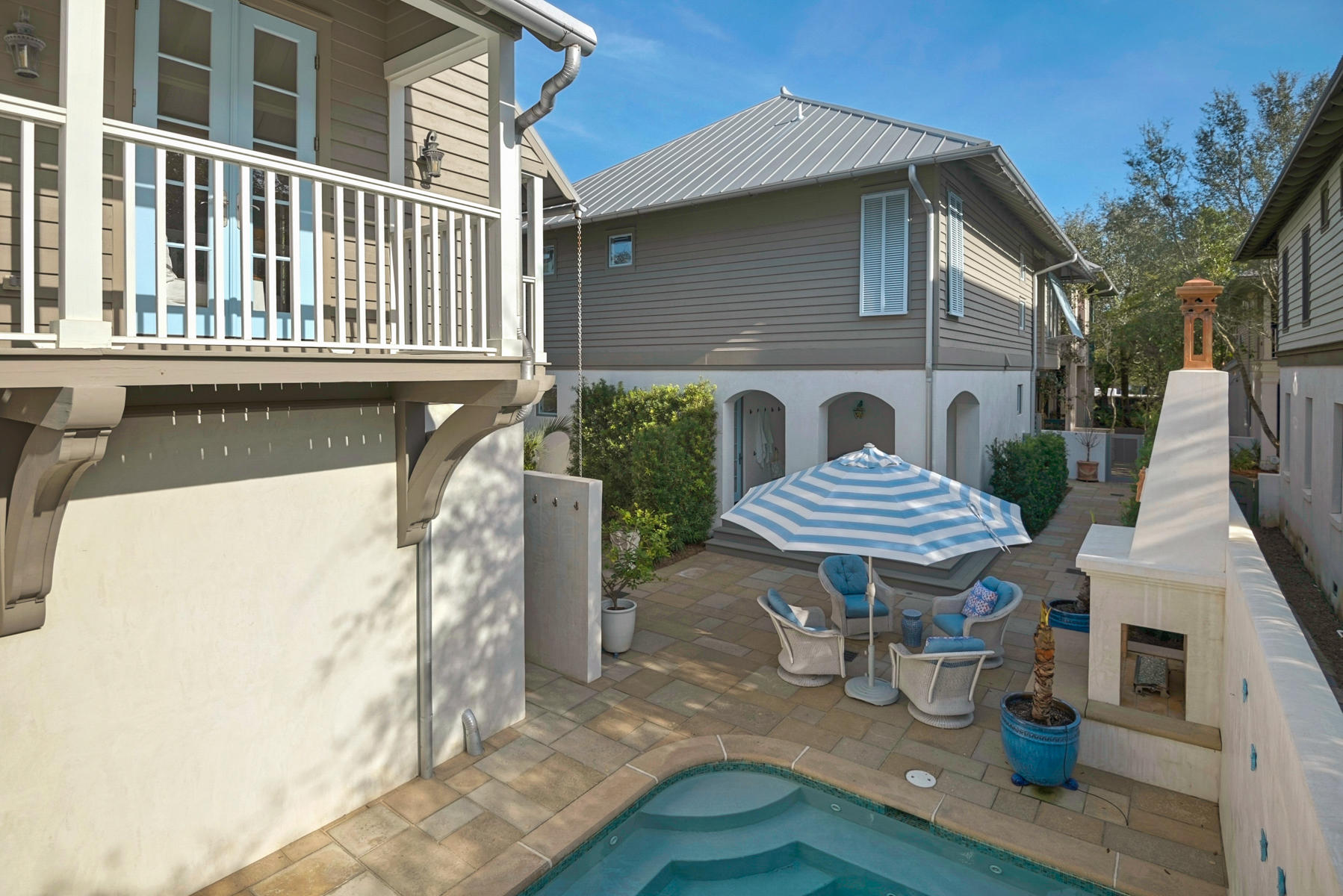 This generous corner lot host a Main House, Carriage House, Pool and spacious Courtyard with outdoor Fireplace. Level 1 enjoys the open Living/Dining/Kitchen as well as a Media Room/1st floor bedroom with en suite bath. Level 2 is accessed by a sweeping stairway and entertains the Master Suite, Guest and Bunkroom, a cantilevered study and Sunroom overlooking West Kingston Park. The back porch of the Main House leads to the Courtyard with Summer Kitchen, outdoor Fireplace, Pool with 10 Jacuzzi jets and Fountain. A private entry to the Carriage House allows Guest autonomy during a visit. The Carriage House provides a garage on Level 1, an open Living area with breakfast bar & full kitchen, plus bath on Level 2, and a spacious Bedroom with a King and 2 built-in queens and half bath on 3