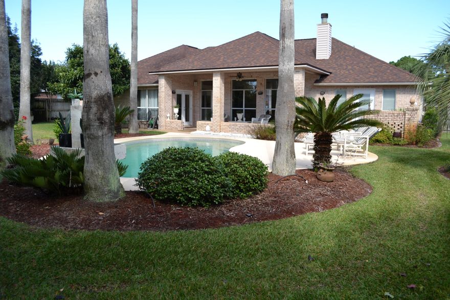 When you enter this beautiful property, you will feel right at home. The high ceilings, large windows overlooking the lush back yard with pool, and open floor plan provide light and warmth at the beginning of your experience. The kitchen has been remodeled with stainless appliances and granite counter tops...for someone who enjoys cooking or entertaining...a dream come true! The elegant Master Suite is large and private and has a wonderful master bath with a closet large enough to keep most any husband and wife comfortable! The house has been exceptionally maintained. Enjoy the covered lanai as you relax by the pool. This fabulous home is ready to move in just in time for the holidays.