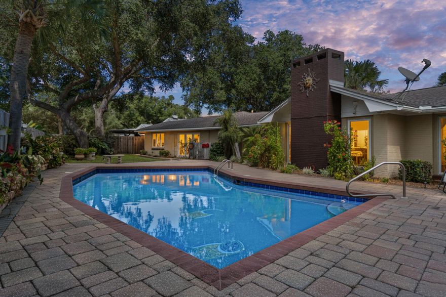 From the moment you step inside this fully renovated designer home, you'll be captivated by its exquisite attention to detail & sophisticated high-end finishes throughout. A stunning foyer with mosaic tile compass inlay incorporated in marble flooring, vaulted ceilings & gorgeous chandelier set the stage for the elegant living spaces beyond. An expansive main living area features bamboo flooring, dramatic vaulted ceilings with cypress beams, striking marble fireplace & 2 built-in travertine display niches with glass shelves. Formal dining room is graced by 2 Waterford crystal chandeliers, overlooking a lush landscaped backyard, heated pool & spacious paver entertaining areas. Walls of windows throughout offer natural light & provide sweeping views of the manicured front grounds & circular drive. The chef's kitchen is a true showpiece, showcasing custom cabinetry, granite countertops & Spanish tile flooring. 5-burner gas cooktop, gas oven, 4-door refrigerator & pantry with bamboo shelving. Kitchen offers bar seating & opens to a dramatic great room with cypress ceiling beams, a granite-clad gas fireplace & a sunroom-style breakfast area with pool and garden views. A full bath with tile flooring, granite shower & granite countertop vanity are easily accessed from pool. Spacious laundry room with Affinity washer & dryer, utility sink & abundant cabinetry connect to the kitchen & oversized 2-car garage with cabinets & a storage room. Elegant primary Suite is a serene retreat, featuring travertine flooring, dual ceiling fans, walk-in closet & French doors leading directly to backyard pool. Adjoining private office with custom mahogany built-ins provides the perfect space for remote work or quiet reflection. Luxurious primary spa-like bath with marble flooring & dual vanity countertops, marble walk-in shower with 6 massage heads & 2 large closets. 2 beautifully appointed Guest Suites each featuring their own tiled en-suite bath, finished with marble & designer glass accents & 1 highlighted by a Swarovski crystal chandelier. Spacious backyard private sanctuary designed for both relaxation and entertaining complete with mature tropical landscaping, outdoor lighting, built-in stainless steel grill with dual burners & direct access from master suite & breakfast area. Located just steps from the Bay, this extraordinary home offers a rare combination of luxury, comfort & refined design - perfect for elegant living & effortless entertaining. Hurricane rated windows & doors. Indian Bayou Community has low HOA fees & sidewalks throughout the Community. Indian Bayou Golf & Country Club is a semi private Golf Course featuring a Bar & Grill. All information deemed to be correct, but buyers agent to verify all data & information important.

