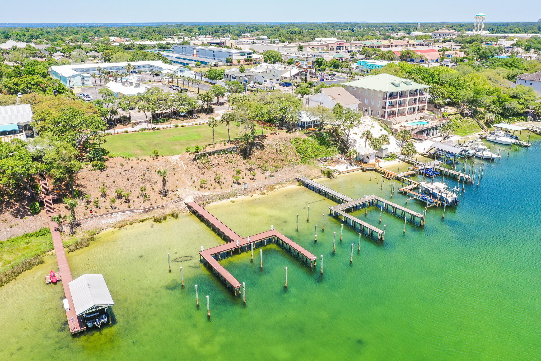 100'' of PRIME WATERFRONT. This .51 of an acre located in the heart of Destin Florida. Large Lot is situated on one of Destin's highest bluff's overlooking the beautiful harbor. Watch the dolphins and lot's of other wildlife in your own backyard! The sunsets are simply amazing and will recharge your soul! If your a fisherman or watersports enthusiasts you will enjoy this property immensely. This is one of 2 lot's available purchase. Buy one or assemble both for a 1 acre waterfront estate. It comes with 4 Deep Water Boat slips per lot that can accommodate large or small boats. The lots have been cleared and ready for you to build your dream home.