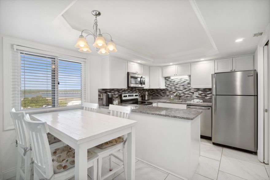 Owner financing is being offered on this turn-key condo.  Owner financing options include 3.5% for the first year! Pinnacle Port is a delightful condominium located within the gated community of Carillon Beach. This idyllic, 2-story residence affords waterfront views of both the Gulf of Mexico and Lake Powell.  Upon entering, you'll be captivated by the stunning Gulf views that fill the living, dining, and kitchen spaces.  The second floor of this unit is where you will find the primary bedroom, an ensuite bathroom, and its own balcony overlooking Lake Powell. The second floor also boasts a guest bedroom with its own private bathroom and views of the Gulf, providing a comfortable and inviting oasis for owners and guests alike.