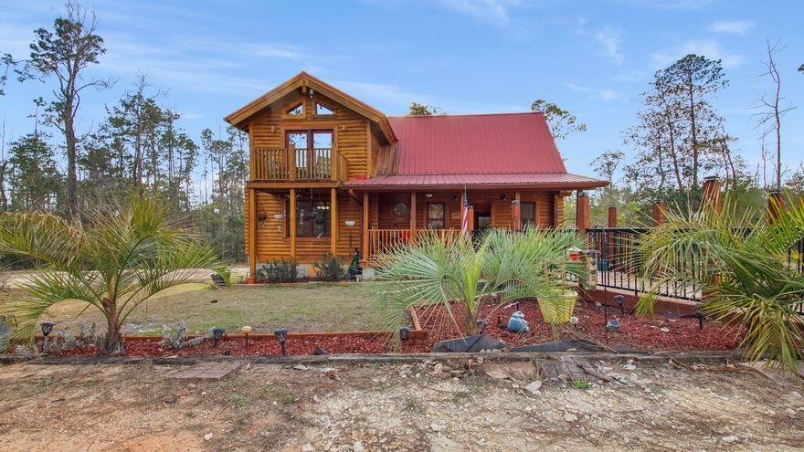 Here's your chance to own this beautiful Australian Cypress Log Cabin, located in Compass Lake in the Hills. Peace and Tranquility are the words that come to mind when you first step foot on this 3.75 acre property. This home offers 2 large bedrooms, each w/ its own bathroom. The Primary bedroom has a private balcony, in the bathroom you have a double vanity, extra closet, tub, and a separate shower. Outside of the primary bedroom there's a loft that overlooks the sunshine filled family space and has an amazing view of the diverse nature on this property. On the main level you'll love the open floor concept with its vaulted ceilings, floor to ceiling windows for natural light, and new custom kitchen. The Kitchen features black granite countertops, an island with a built-in wine rack