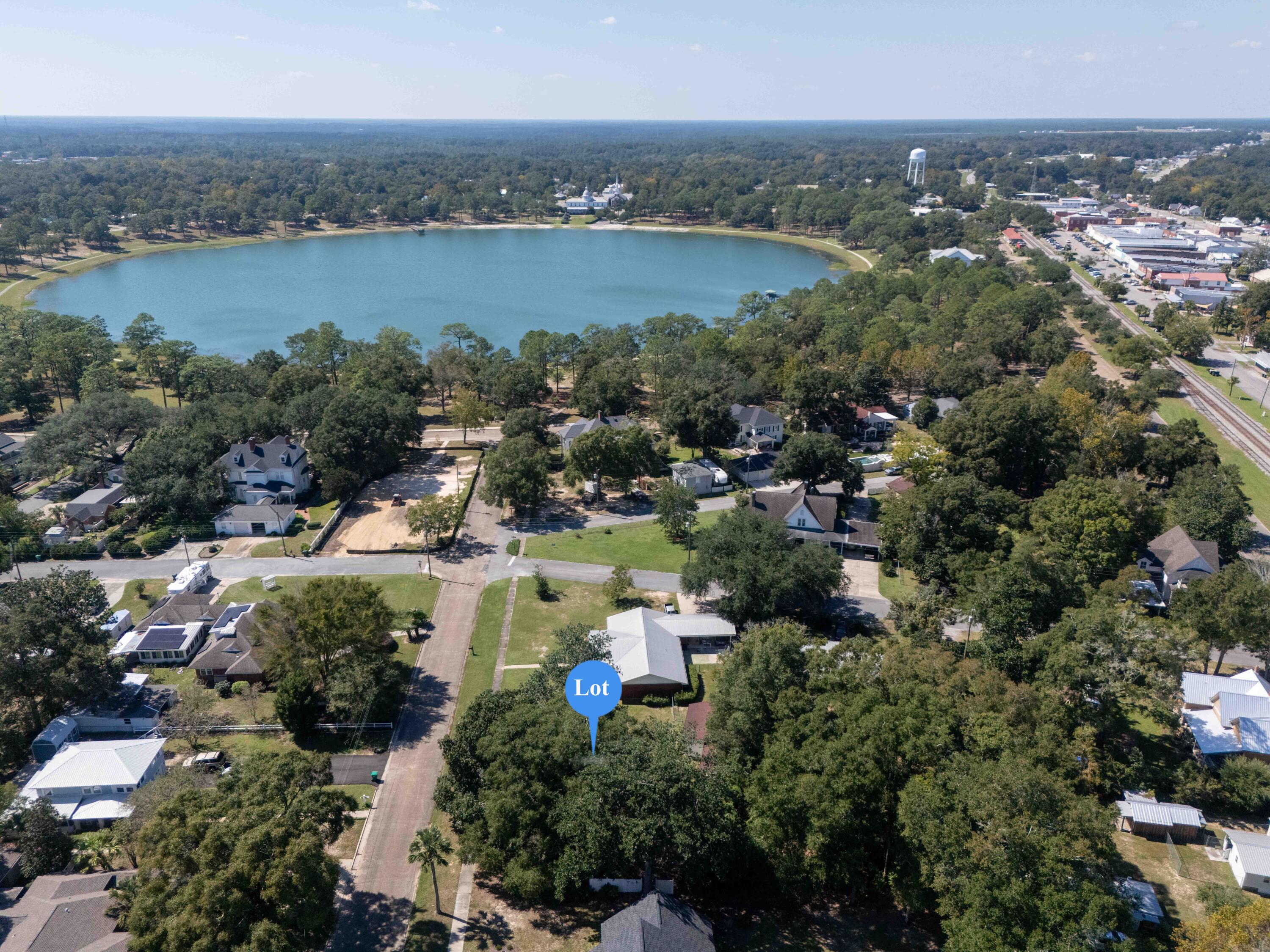 Rare vacant DeFuniak Springs historic district lot just 1 block to Lake DeFuniak! There are only a handful of existing vacant lots in the entire district, so don't miss your chance to build or hold for investment. The perfect smaller lot at 50' wide, for that cute cottage you've been thinking about. There are no restrictions for short term rentals and would create rental income or be a wonderful primary home also. Historic district guidelines in docs section of MLS. Just one block from waterfront sunsets, from parade-watching, from the renowned Christmas Reflections and from neighborhood walks. Just a few blocks more and you're in vibrant downtown for shopping and dining. Electric, water and sewer available. If you've been dreaming of a southern Hallmark town experience, this is it!