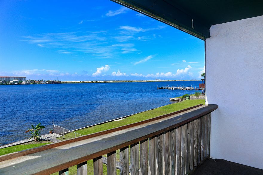 Waterfront condo with incredible sunsets and water view!! This two bedroom condo has granite in the kitchen and baths, custom oak cabinets, title floor downstairs and wood flooring upstairs. Living room and Master Bedroom both have insulated walls for better energy efficiency and sound proofing. Bright and light living and dining area. Sliding glass door off the living area to the balcony overlooking the large grassy lawn with the private dock on the sound and views of the Gulf of Mexico. Great area for the kids and pets to play. Full size washer and dryer does convey. Seller purchased Old Republic Home Warranty for Buyer. Buyer to verify all data important to them.