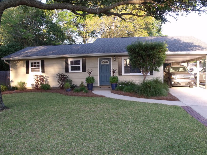 Remodeled and well-maintained! This little gem has been updated over the last several years to include laminate and tile flooring with extensive trim work throughout. The kitchen has wood cabinets, travertine counter tops, tumbled travertine backsplash and includes a pantry for additional storage. You'll also find a built-in breakfast bar just off the kitchen in the family room which is great for entertaining. One of the bedrooms has a double closet and the rear bedroom has a built-in storage area complete with a charging station for electronics. The house gets a lot of sunlight throughout the day with morning sun to the rear and evening sun to the front. On the exterior, the lawn has been well-maintained and there are several landscaped beds with mature landscaping. The carport is