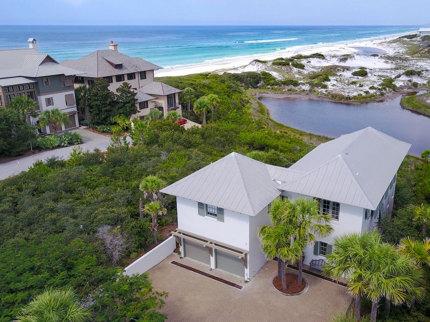Step into the entryway of this tranquil, private courtyard overlooking the white sand of a rare coastal dune lake and spectacular views of the Gulf of Mexico. Nearly every room of this 2,314 Sq. Ft. home offers incredible vistas that you can only get from the Emerald Coast. This seaside home has 3 bedrooms, 3.5 bathrooms and a bunk room for visitors and guests. A spacious 2-car garage and a large private driveway provide plenty of room for hosting guests and entertaining. Lavish finishes and amenities like wide plank hard wood flooring, granite counter tops, steam tile showers, GE stainless steel appliances and high, wood beamed ceilings are found throughout this home.