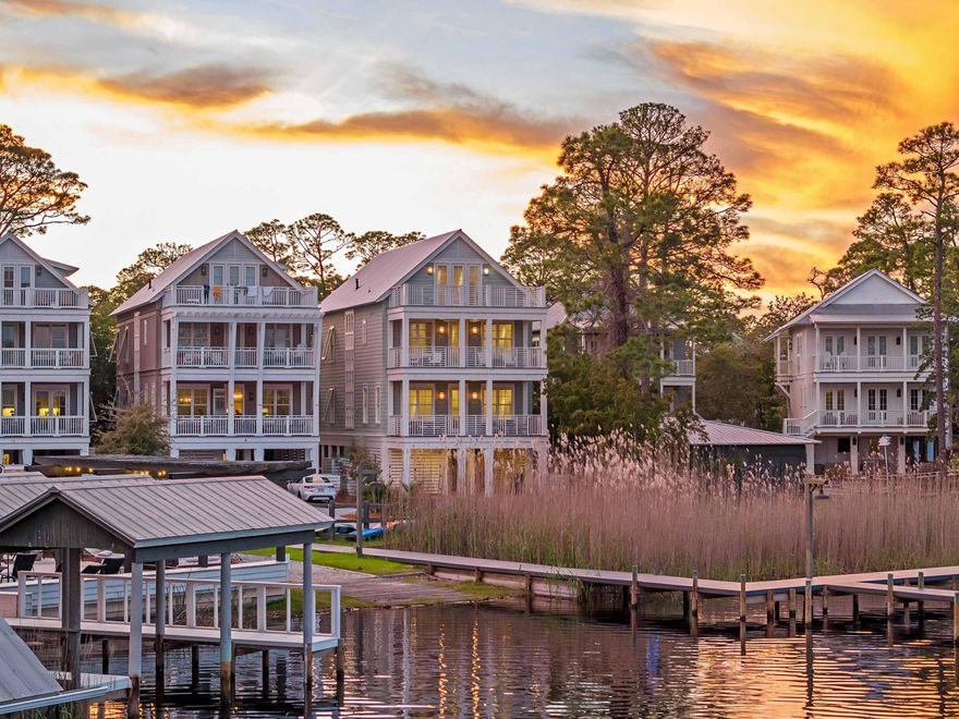 Nestled within the exclusive, gated enclave of Grayton Landing, this custom-built five-bedroom, 5.5-bath masterpiece offers a rare opportunity to own a private sanctuary with breathtaking views of Western Lake. Designed by renowned local builder Luke & Blue, this 3,658-square-foot coastal retreat seamlessly blends luxury, craftsmanship and an unrivaled connection to nature. With private lake access, a deeded dock and boat slip, and just a short five-minute walk--or an easy cruise in your included private six-seater golf cart--to the sugar-white sands of the gulf, this home is a true coastal dream. Step through the gated entrance and into a refined coastal retreat, where panoramic lake views instantly set the tone. The second level welcomes you with expansive windows that flood the space with natural light, drawing your eye toward the serene waters of Western Lake. A chef's dream kitchen awaits, designed for both beauty and function, featuring solid wood cabinetry with dovetail joinery, soft-close hardware, marble countertops, a Wolf 36" four-burner gas range with griddle and a built-in Sub-Zero refrigerator.

The open-concept living and dining areas exude warmth and sophistication, seamlessly extending to two covered porches, perfect for al fresco dining, morning coffee or evening cocktails overlooking the tranquil lake and resort-style community pool. The primary suite on this level is a private escape, complete with a custom walk-in closet and a spa-like en suite bath showcasing dual quartz-topped vanities, multiple showerheads and a freestanding soaking tub designed for ultimate relaxation.

Ascend the elevator or custom staircase to the third level, where three additional bedrooms and a full laundry room provide a retreat for family and guests. Two west-facing bedrooms boast ensuite baths with custom cabinetry and quartz countertops, one featuring a walk-in closet, the other offering dual storage closets. The second primary suite on this level offers a private covered porch with spectacular lake views, making it the ideal space for quiet mornings or unwinding after a day on the water. The ensuite bath is a true spa experience, featuring multiple showerheads, double vanities and exquisite high-end finishes.

The fourth level is an unexpected delight, featuring a custom-built bunk room with four closets  a space thoughtfully designed for younger guests or extra accommodations. A wet bar and cozy loft area lead to an expansive open-air porch finished with high-resistance Trex decking, where you can soak in the unparalleled beauty of the lake and the surrounding coastal landscape.

Grayton Landing is an exclusive, gated community of just six residences, offering residents a private and serene lifestyle along Western Lake. Spanning 1.5 acres of prime waterfront, this boutique enclave boasts a resort-style community pool with a sundeck, outdoor kitchen and grill area, as well as private access to the lake via a dedicated boat ramp and deeded dock with assigned slips. With 175 linear feet of lake frontage and the gulf's sugar-white sands just minutes away, this is a rare opportunity to own a private slice of paradise along 30Acomplete with your own six-seater golf cart for effortless coastal cruising.