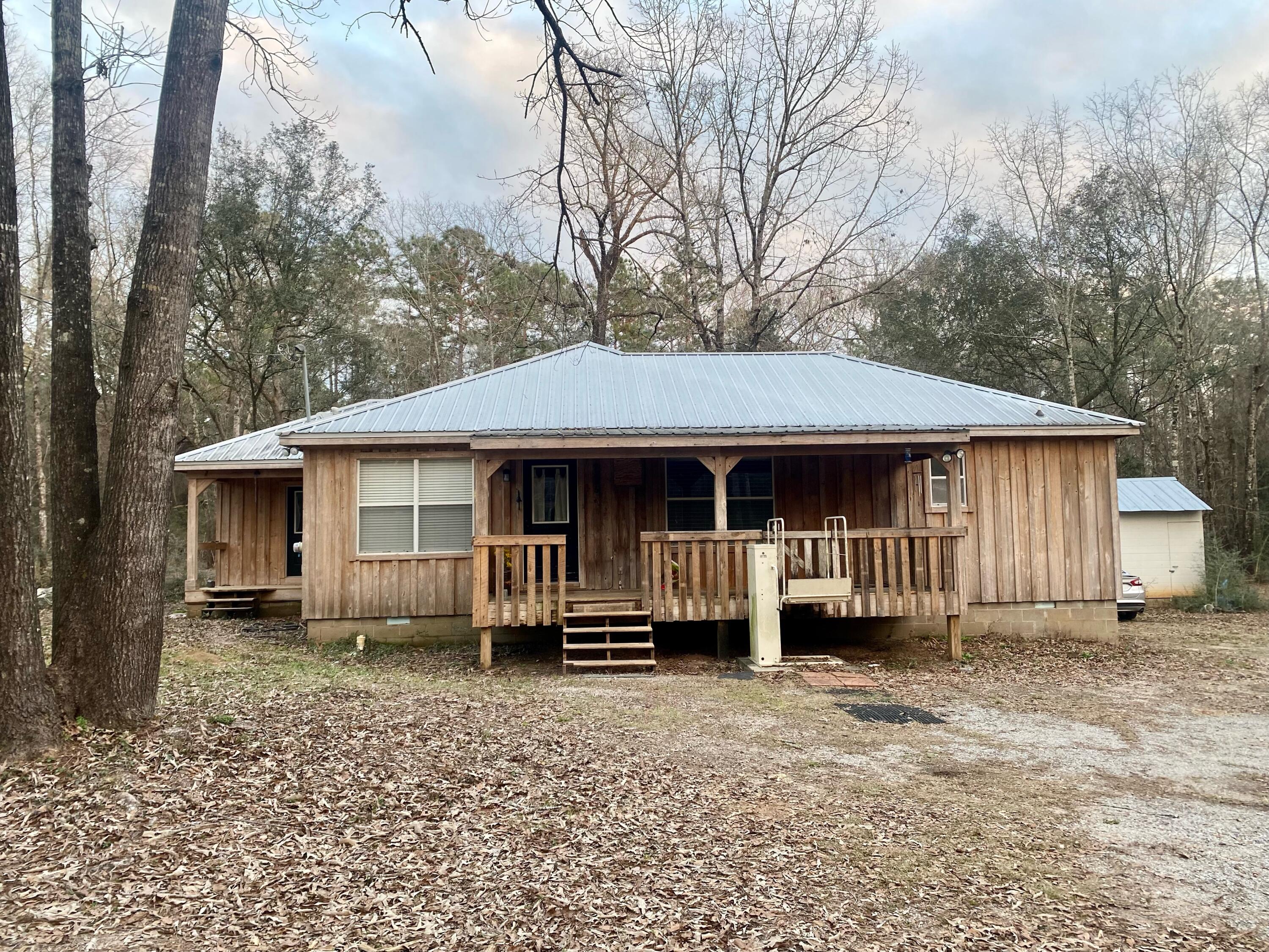 This three-bedroom cabin style home built in 1999 is located just off Pleasant Home Rd and nestled on a beautifully wooded four acre lot. As you drive up you notice the cedar siding and the metal roof. The front porch offers a great place to relax and enjoy some down time. This home is in close proximity to Blackwater State Park offering easy access to the hiking and horseback trails. The property also has a 1200 sq ft barn that is a great addition to any homesite. Don't let this deal pass you up. Call today to schedule your showing time!