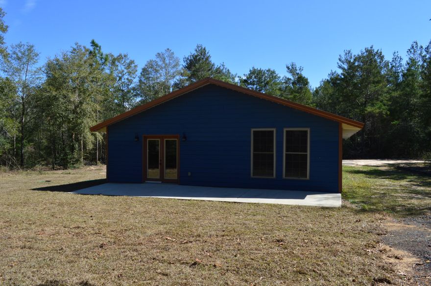 Practical and efficient 3 bedroom and 2 bath home on just shy of 2 acres in a private setting. Home features 2'x6' construction, slab on grade with spray foam insulation throughout. Roof and trim are 40 year manufacture warranty metal and siding is hardy board. Split bedroom design with open concept kitchen and living room. Master bedroom is spacious with ample closets and private master bath. Home is tile throughout for ease of cleaning and maintenance. Stained wood work throughout as well for unique touches.  If you've been looking for a solidly built home with room to spread out.  Large attached carport for covered parking/storage or outdoor entertaining.