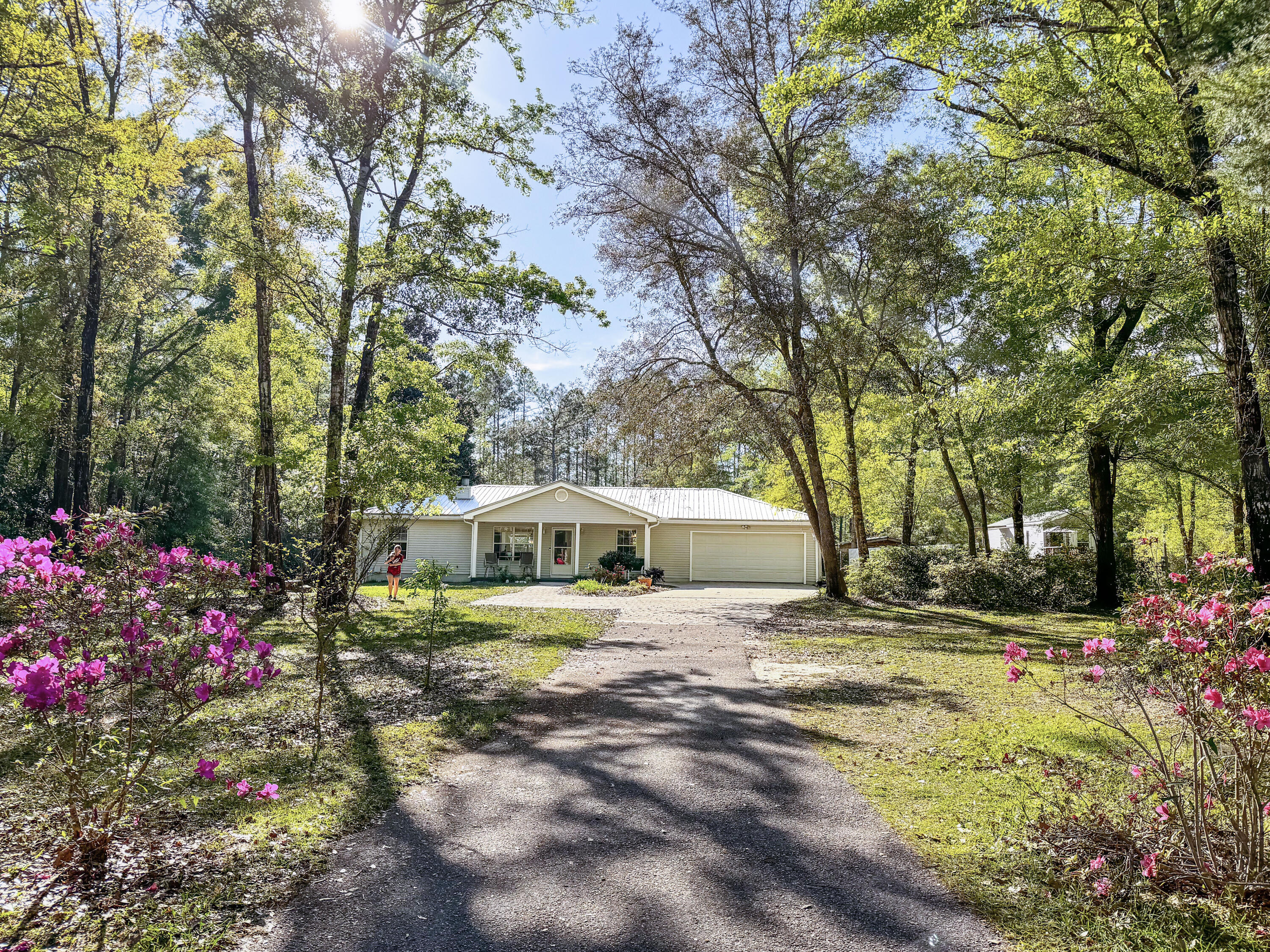 $5k toward Buyer for closing costs, rate buy down or prepaids. COUNTRY living with easy access to Black Creek & 30a Beaches! Lush 1.05 acre, spacious 3B/2Ba/2car garage. Recent upgrades: Samsung refrigerator, stove, dishwasher and microwave 2020. Quartz countertops, kitchen sink, 2023; Wood burning fireplace, New walk-in shower in master bath; New LVP Floors, 2023; HVAC 2015; Metal Roof 2016 and Allergan Air Purifying system, 2021 Full irrigation. Large fenced in backyard, property continues past tree line with so much space. Concrete and brick pavers front driveway. Fresh painted exterior.