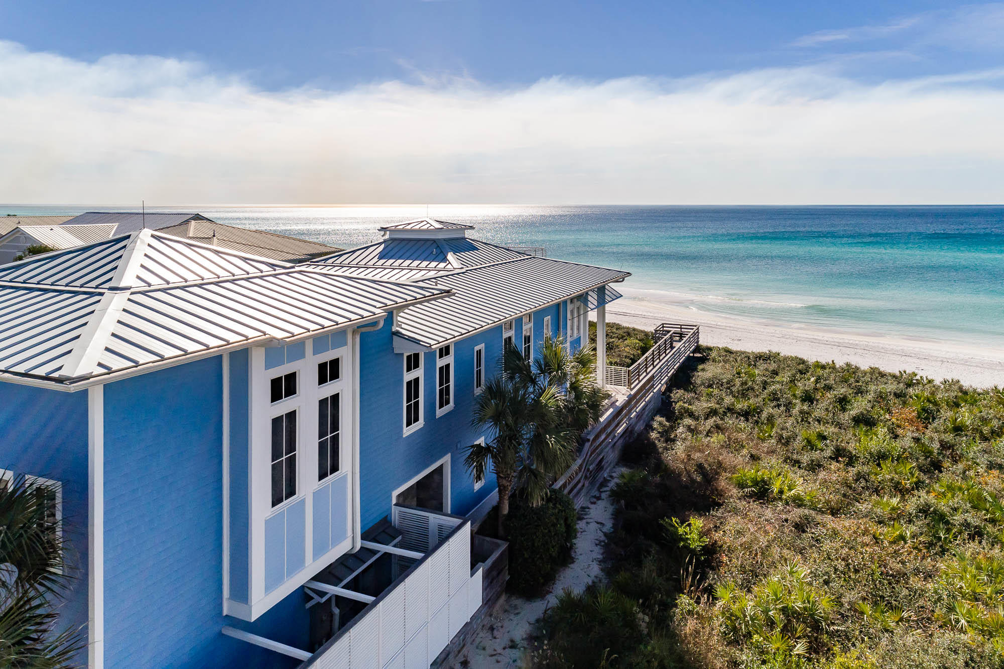 This expansive home nestled in Seagrove Beach offers a beautiful beachfront location with panoramic Gulf views sure to take your breath away. A private courtyard leads you to the entrance of the home. Inside, you're greeted by a light-filled open concept dining and living room complete with panoramic views of the Gulf of Mexico, a gas fireplace and plentiful built-in shelves. The gourmet kitchen boasts coffered ceilings and an impressively large island with seating for eight, two pantries, dual Wolf ovens, dual Wolf warming drawers, an oversized Thermador gas cooktop, and a Sub Zero Refrigerator and Freezer. French doors usher you from the main living area onto the spacious private deck overlooking the beach.