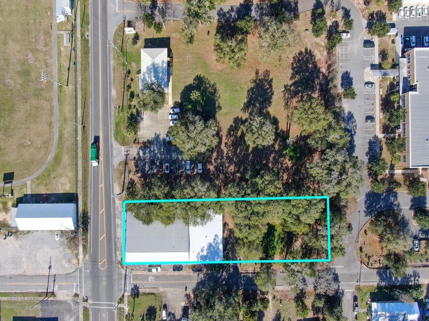 Excellent opportunity to own a vacant lot plus sturdy block building just shy of 11,000SF located across from Harbeson Field on the corner of N 9th St. and Burdick Ave. Zoned C-2 AND includes the vacant lot to the east as well. Building and lot were just appraised for $265,000 together, for a serious bargain. The building has many possibilities and layouts with separate offices, 3.5 baths, 2 HVAC units and some serious electrical boxes & upgrades throughout. The vacant lot next door is zoned C-2. The Walton Co Health Dept is located around the corner 1 block away, 4 blocks from historic downtown DeFuniak Springs and the Walton Co Courthouse is 5 blocks away.
