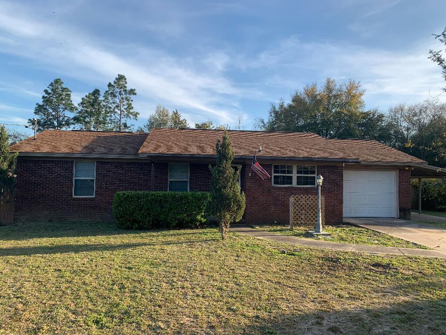 3 BEDROOM, 2 BATH BRICK HOME ON FENCED .57 ACRE. HOME HAS AN OPEN FRONT PORCH as well as a Florida Room on the back of the home.  There is an attached carport and a detached GARAGE plus additional sheds on property.  Fresh paint and new carpet.