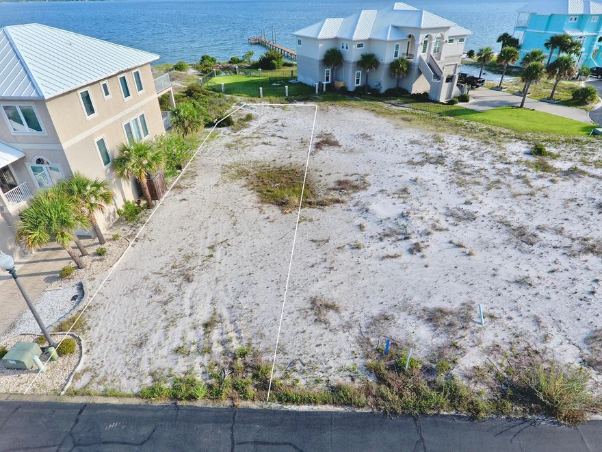 Navarre Beach Lot with Direct WATERVIEWS backing up to Conservation area on the Santa Rosa Sound. Build your Dream Home here on one of the Larger Lots in the community and enjoy the quiet & Gated neighborhood of Caribbean Isles, which features a community pool, tennis courts, street lights and underground utilities. Enjoy this beautiful beach community on the Sound or take a short trip, only 1/3 mile to Gulf of Mexico beach accesses. Caribbean Isles is a well-maintained community bordered by approx. 30 acres of county-owned beach land to the west and the majestic Santa Rosa Sound to the north, where you can enjoy breathtaking sunsets and plenty of water activities. Click ''More...''