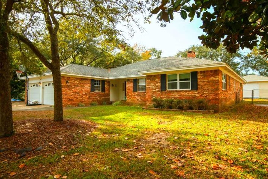 WELCOME TO YOUR GOLF COURSE HOME. Located on the 7th hole in the Desirable Lake Lorraine Community of Shalimar Florida. Before you step in take in the water view across the street. This spacious home has everything you need to include a 400sqft workshop with covered porch to relax & enjoy the summer breeze. The front door opens to a spacious foyer awaiting your Pintrest favorites. Shinny wood floors span the nearly 600 sqft of open living room space accented by a beautiful brick old fashion fire place. Look closely their is built in storage to keep your fireplace wood & tools. Spacious bedrooms 1 and 2 share a nice size jack and jill bathroom. Also located on the front right side of the home is Bedroom 3 and a half bath quietly tucked in the hall way. This home is definitely built for th entertainer with the large kitchen with tons of country designed shaker cabinets, Corian counter tops,  2016 5 Range Gas Stove, new stainless steel dishwasher & a large composite granite sink.  You will love how the kitchen bar sits off to the side for the chef to conveniently move through their work space. LED Lighting line the under cabinet space with remote controller to adjust color & timing. Kitchen also includes a serving counter into the large dining room. Currently the dining room is set up as an office space in the photos. Interior features also include an office large enough for multiple uses. A laundry room with built in cabinets, a counter top for folding laundry & two extra closets for additional storage. The 2 bay garage is spacious enough for both vehicles and work space around them. The attic includes additional wood planks for walking and storage space as well as brand new pull down stair access. HOME HAS GAS!! BRAND NEW HVAC SYSTEM. 2006 ROOF. 