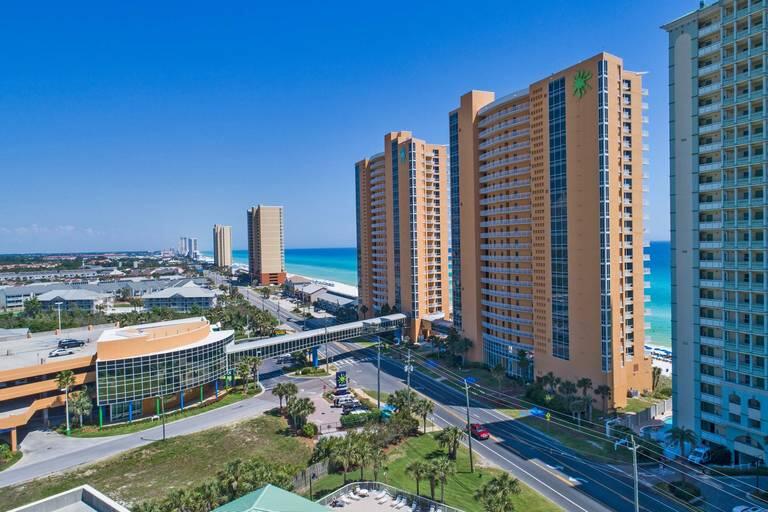 Experience the epitome of beach living at its absolute finest in this breathtaking condo boasting a stunning view of the Gulf. Nestled within the esteemed beach complex, Splash, this exquisite property offers an unapparelled level of fun and exceptional potential for rental income. Situated on the western end of Front Beach Rd, Splash enjoys a coveted location, coupled with an array of impressive amenities that create a lavish resort-style atmosphere, setting it apart from other complexes in Panama City Beach. Well-furnished and radiating with coastal charm, this Gulf-front condo showcases an intelligently designed floorplan that generously accommodates up to six guests. This splendid unit boasts lofty 9-foot ceilings, a spacious primary suite, well-proportioned secondary bedroom, and a remarkable large balcony. The interior enhancements include lavish slab granite counters adorning the kitchen and bathrooms, easy to maintain hard surface flooring throughout, as well as brand new HVAC and washer and dryer units. Meticulously maintained, this exceptional condo is gorgeously decorated and brimming with upgrades, ensuring an unmatched level of luxury.
Splash offers an awe-inspiring array of amenities that drape the ambiance with the magnificence of a true destination resort. Delight in over 400 feet of pristine Gulf frontage, where the warm waves beckon you for an enchanting swim. The resort-style lobby extends a warm welcome upon arrival, while two distinct waterpark environments indulge your senses, featuring a lazy river and whimsical toddler frog and turtle splash pad and an exhilarating water bucket playground. Keep up with your fitness routine at the full state of the art fitness center or unwind at the adult exclusive pool and jacuzzi. Savor the island style atmosphere at the Beach Bar and Grill and take pleasure in covered parking for utmost convenience. Engage in interactive water activities with enticing built in features and satisfy your taste buds with a quick stop at the coffee and snack shop. Further enhancing your experience, Splash also offers covered garage parking, a boutique surf shop for all your beach apparel needs and well as an onsite rental management and check in desk. All of these unrivaled amenities effortlessly converge at Splash, ensuring an extraordinary experience. Situated in the heart of the finest restaurants, shops and entertainment options including the renowned Pier Park, Splash places you at the epicenter of the vibrant PCB scene. Immerse yourself in the exhilarating energy pulsating through this remarkable locale, where every desire is at your fingertips. Indulge in the ultimate beach living experience and bask in the incomparable allure of this remarkable coastal dwelling perched majestically withing the esteemed and unparalleled resort complex of Splash.