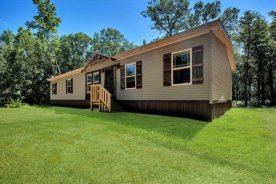 BACK ON MARKET DUE TO NO FAULT OF THE SELLER! Check out this hidden gem!  Welcome to your private oasis, where tranquility meets convenience! This exceptional property is ideally located for those who cherish the peace of a remote setting yet desire the pristine beaches of Navarre just 30 minutes away.  Nestled on a wooded lot, this property has been thoughtfully cleared. The serene cabin-in-Tennessee vibe invites you to relax on your screened-in porch, where you can unwind and enjoy the sights and sounds of nature. When you're ready for some excitement, pack your beach toys and head to the beach! Enjoy hiking, shopping, exploring local breweries, or dining along the way. This versatile property is ideal for full-time living or a great weekend retreat! Don't miss out on this great find!