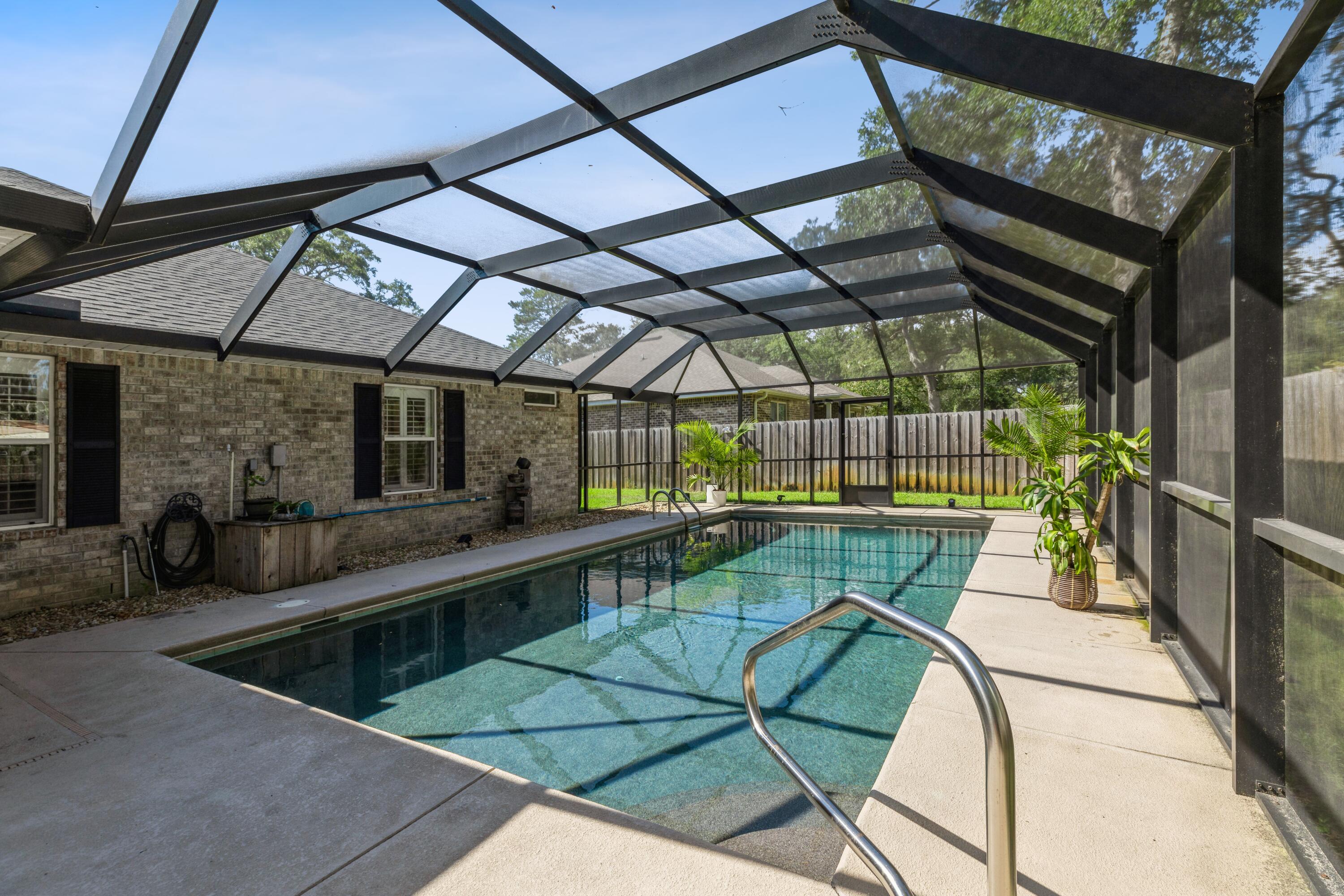 Incredible oasis in the heart of Fort Walton Beach! Beautiful pebble-finish, gunite pool with enclosure & covered patio is just perfect for outdoor entertaining & staycations! Amenities include granite countertops...rich cherry cabinetry...Plantation shutters throughout...counter-height vanities...ceiling fans throughout...tile flooring...crown-molding...paver driveway & walkways! Amenities for 4-legged family members include additional fencing, front-door gate & multiple doggy doors. The 2-car garage also features a pull-down screen with access door! Convenient to Eglin AFB, Hurlburt AFB, beaches & attractions, Destin-FWB Airport, FWB Municipal Golf Course, shopping & restaurants