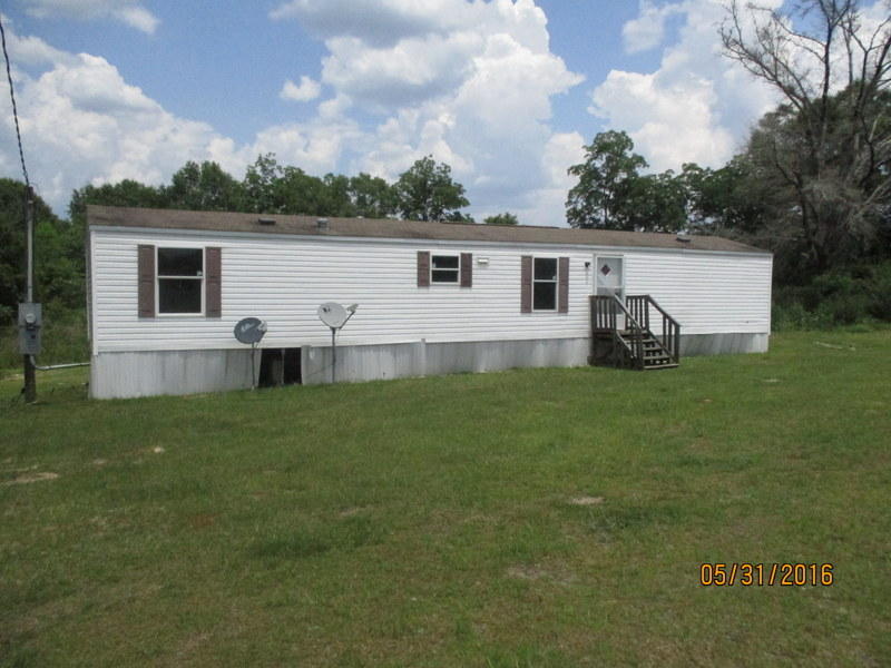 A Single wide mobile home resting on .99 acres, this 2 bedroom 1 bath REO home was built in 2005 and has split bedroom design, great room and open kitchen. Home needs repairs but is an investor's dream. ** Seller is willing to rent or seller finance this property** Please inquire to agent for details. Call before this home is gone.