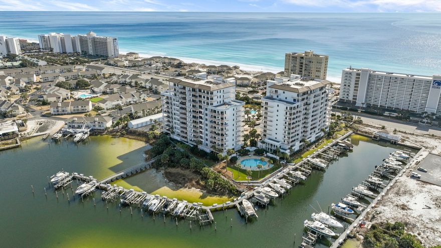 Experience the beauty of Destin Harbor from nearly every room in this elegantly finished residence. With a prime western exposure, enjoy dramatic sunsets, festive boat parades, and weekly Thursday night fireworks--all from the comfort of your condo.  Inside, a neutral palette and airy design elements create a serene, inviting atmosphere that complements the vibrant scenery outside. New LED light fixtures add a warm, energy-efficient glow throughout. The kitchen is equipped with brand-new stainless steel Whirlpool appliances, classic granite countertops, and light cabinetry that enhance the condo's bright and open feel.  Thoughtfully laid out, the floor plan is both functional and stylish, ensuring effortless daily living and a seamless connection to the outdoors. Watch dolphins play, manatees glide by, and ospreys and herons soar- your window to nature awaits.  Located in the gated community of Harbor Landing, residents enjoy access to two sparkling pools, a fully equipped workout center, deeded beach access, and a private marina. The unit includes a designated covered parking spot for added convenience. A new AO Smith 50-gallon electric water heater was professionally installed in April 2025.  Two new screen doors were installed on the living room and master bedroom sliding doors in September of 2024.  Don't miss the opportunity to own a piece of paradise where natural beauty meets modern comfort.

