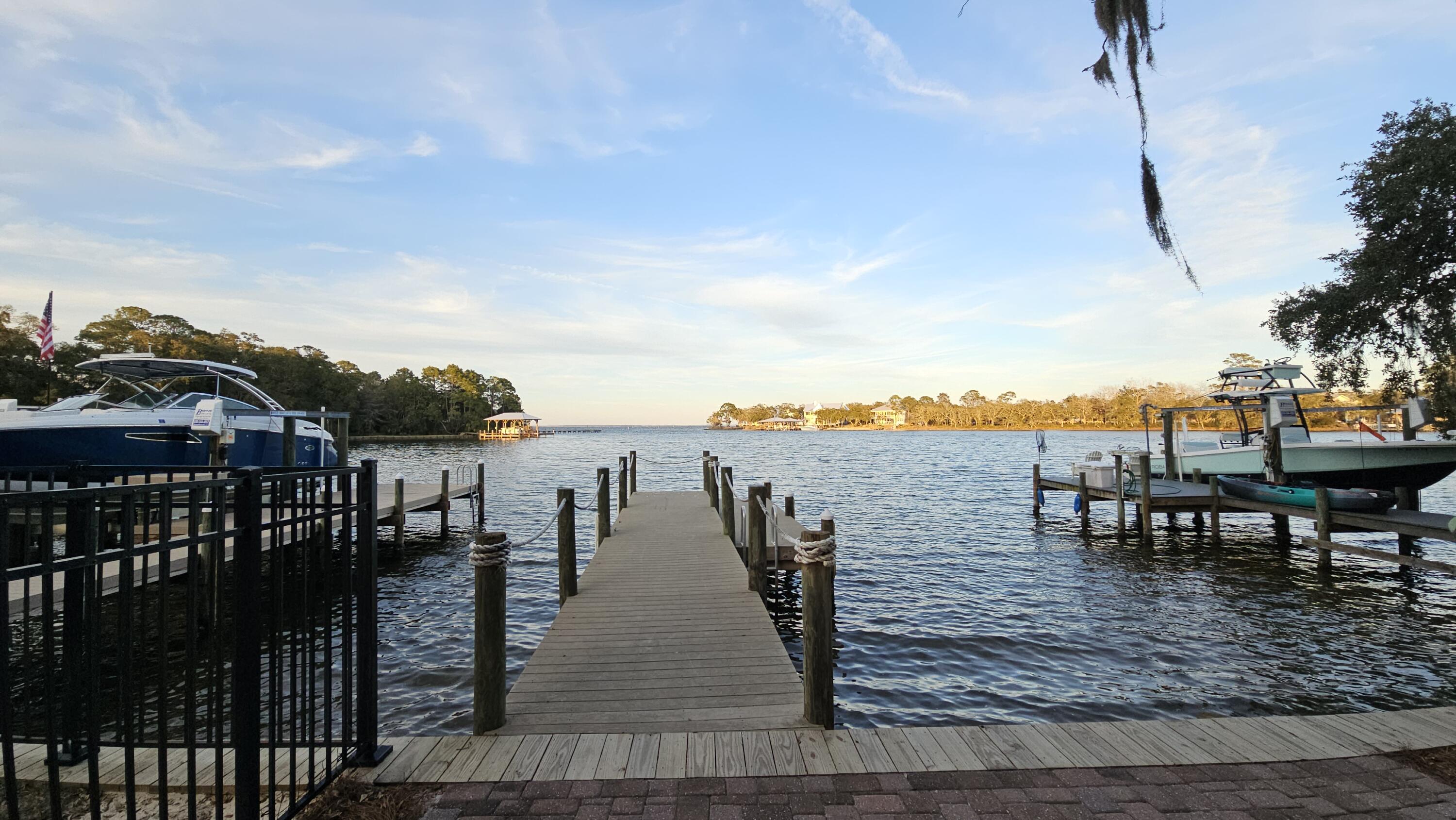 PET FRIENDLY~Charming two-story residence nestled in the serene waterfront community of Sacred Oaks in Santa Rosa Beach, Florida. Community dock. This inviting home offers 2 stories, 3 spacious bedrooms and 2.5 well-appointed bathrooms within its 1,600 square feet of living space. Open floor plan as you walk in. Modern kitchen equipped with granite countertops and tile flooring, stainless steel appliances, plenty of cabinet space. Through the french glass doors you enter into the outdoor living area. There is a grilling area, shed table chairs, your own personal oasis. All Property Management on the Panhandle residents are enrolled in the Resident Benefits Package (RBP) for $50.00/month which includes liability insurance.