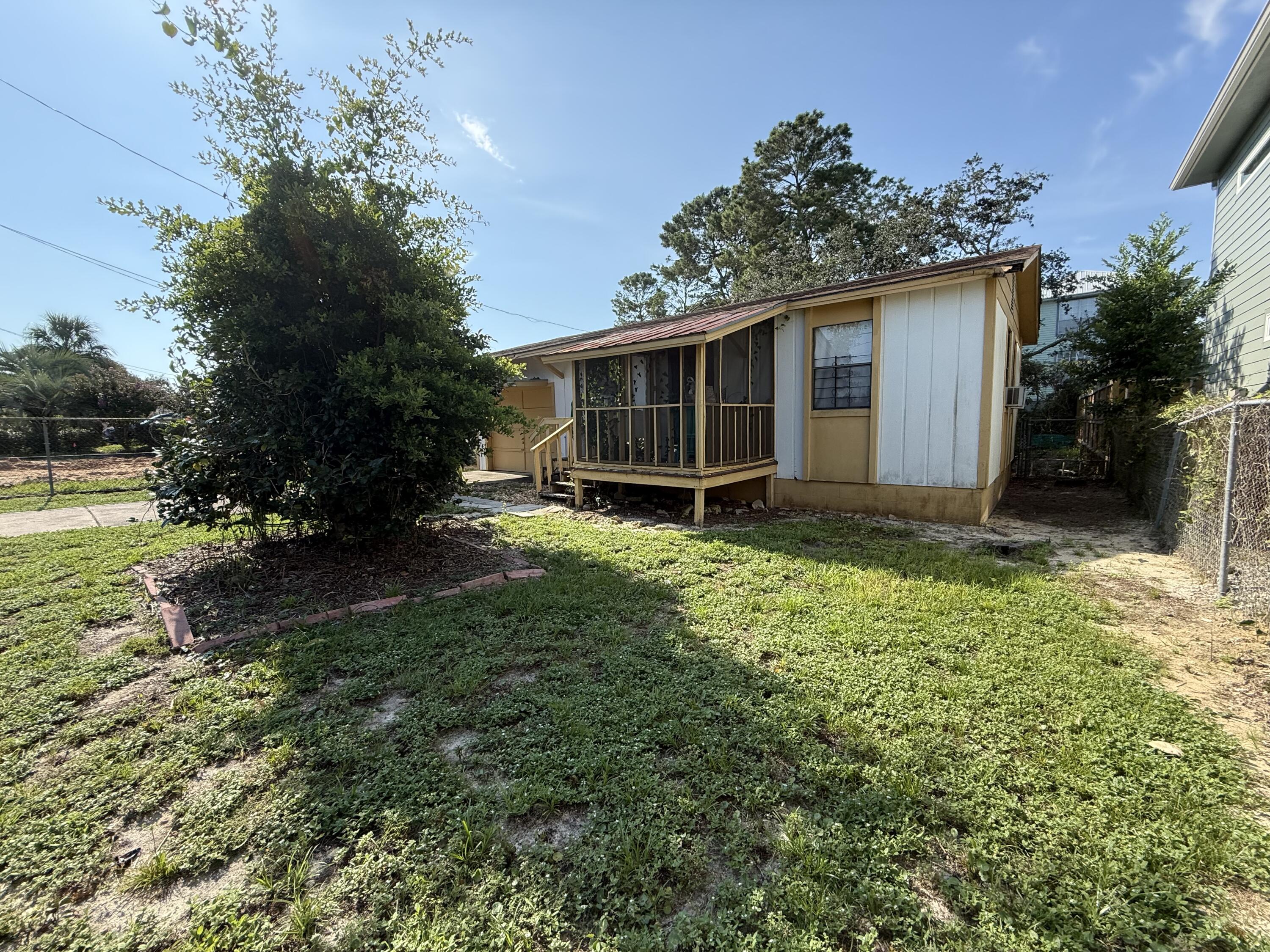Investor special! Don't let this diamond in the rough get away! Check out this original beach bungalow! Built in 1979, this vintage tiny home was built on a fantastic lot in a great location on the coveted west end of Panama City Beach, just a mere 4 blocks to the emerald waters of the pristine beaches of the Gulf Coast! There is so much potential to bring this house into it's future glory! With the small, well appointed footprint and all of the utilities in place, this would be a great project house! Turn it into an AirBnB, a vacation getaway or even a primary residence, there are so many options! This street has a lot of new construction and larger houses being built so there would be an opportunity to clear the lot and have a fresh canvas for a new construction as well!!