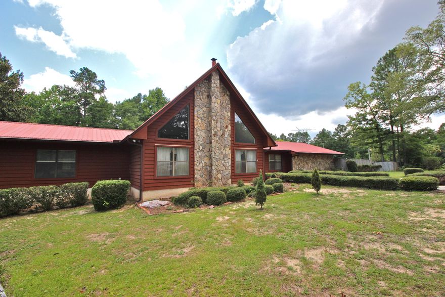 Country living just 2 minutes from town! On 5 acres, this creekfront nearly 3200sf home has soaring ceilings in the family room with a beautiful stone wall and big windows for a bright cheery space that reminds you of the mountains. Brand new laminate floors throughout. Plenty of room to roam with large rooms, an upstairs loft, sunroom and huge converted garage with the same beautiful floors. It could be used as a playroom, movie room or even customized into separate living quarters. The master bedroom has a private back deck, a walk-in closet and plenty of cabinet/storage space in the bath. Two bedrooms share a jack and jill bath. There's no lack of storage inside the house or out, with 2 storage buildings as well. Seller is paying $7500 in buyer closing costs with full price offer!