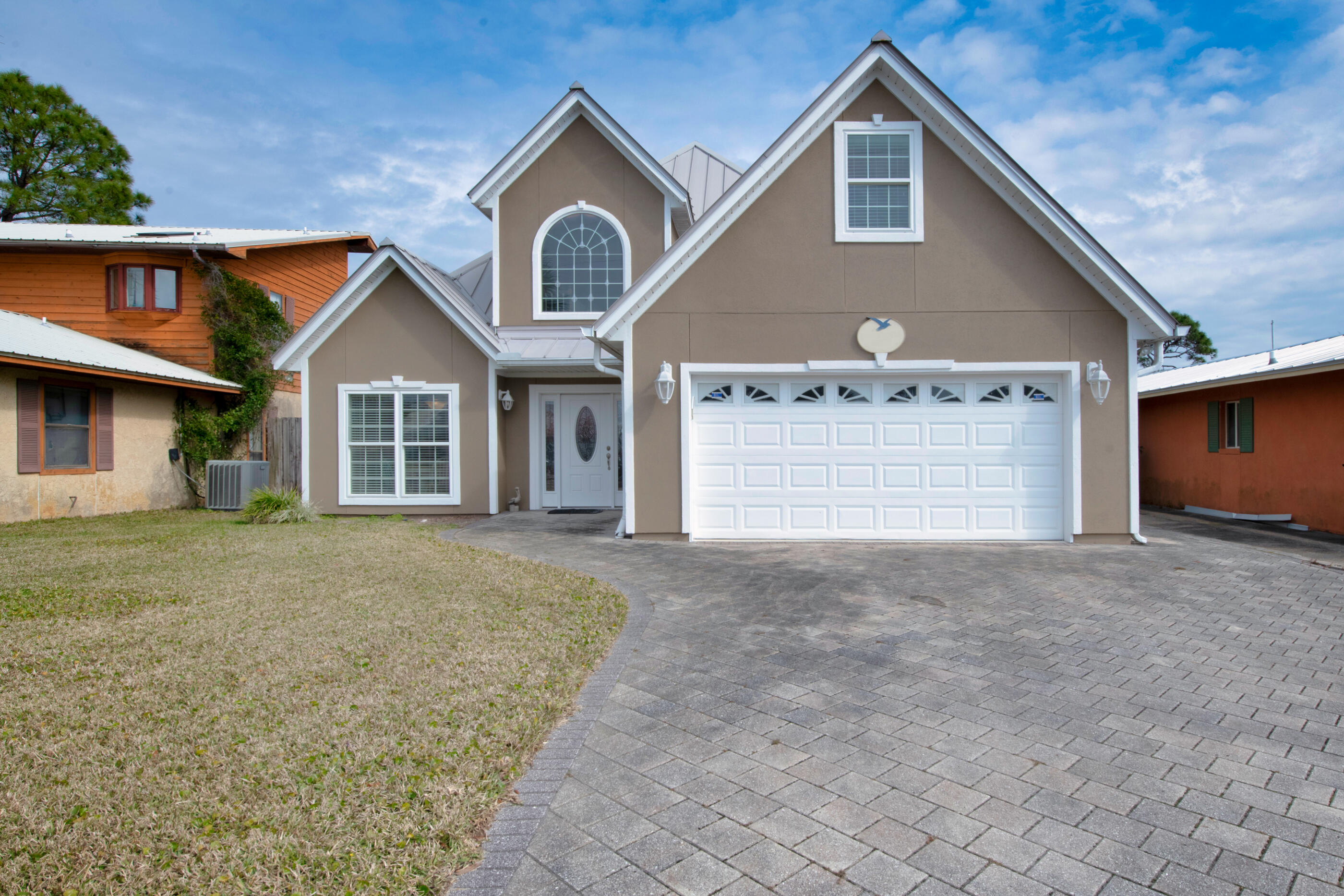 Enjoy relaxing in your home on the lagoon with access to St Andrew Bay to the Gulf of Mexico. Home feature 3 bdrms, 2 1/2 bath with a large bonus room over the garage. Crown molding throughout most of the home. All bedrooms have carpet, tiled flooring in the living room, kitchen, bathrooms and laundry room. Entrance to the home has wood flooring and the landing to the second floor. Large living room with built-in cabinetry, propane gas fireplace and french doors leading out to the covered porch and brick paved patio leading to the boat dock. The boat dock has a 24 x 13 boat slip 8000 lb lift and 2 wave runner lifts. Standing seam metal roof and stucco siding. 2 car garage with brick paved driveway and sidewalks. Restaurants, recreation, shops and more. Buyer(s) are