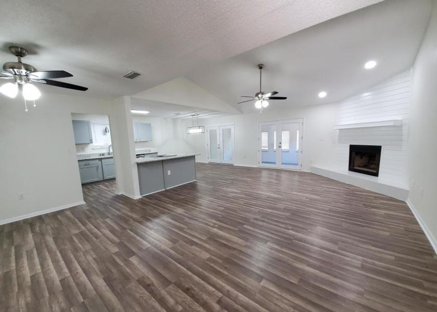 Beautifully updated 3 bedroom 2 bath home in desirable Bluewater subdivision. This property features a wide open floor plan with tall ceilings, stunning fireplace with quartz hearth, new kitchen with breakfast bar and granite countertops, stainless steel appliances, new flooring, and fresh paint throughout. Huge attached florida room. Large fenced in back yard. Indoor laundry room. Two car garage. Additional walk in closet space in master bedroom. This unique property would make the perfect family home. Vacant and easy to show.