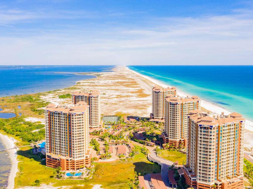 Move into one of the most sought-after condo developments on Pensacola Beach, FL - Portofino Island Resort and Spa. This gorgeous 2BD/2.5BA condo offers spectacular views of the Gulf of Mexico and Intracoastal Waterway as far as the eye can see. This beautifully furnished residence is the quintessence of classic luxury living on the Gulf Coast. Step inside and you will first notice the large tiled floors under your feet that lead throughout you throughout the entire condo to your spacious living area that will accommodate your family and host plenty of guests.  Each of the two bedrooms include a private bathroom and there is an additional half-bath in the living room too!  Take advantage of your fully equipped kitchen with everything that you would need to cook a fresh catch from the Gulf or whip up snacks to take to the beach with you.  After a sun and sand-filled day, toss your swimsuits and towels right into your in-unit washer and dryer.  Enjoy a cup of coffee or tea and soak in picturesque sunrises and sunsets with friends and family in the comfort of your own condo from your private balcony.  The location is the best in the complex  Tower 4 is situated next to the ever-popular Portofino Lifestyle Center where all the fun happens!  You will be able to enjoy fabulous resort amenities such as fitness center, spa locker room, hot tubs, sauna, pools and entertainment. Additional amenities and services available on-site include European Spa, beach service, fitness classes, tennis lessons, on-site restaurants and much more.  Whether you are looking for full-time residency at the beach or your next rental investment, Portofino 4-902 is for you!