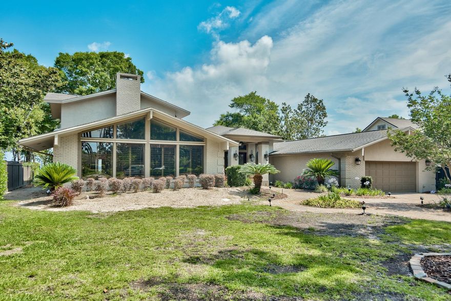 This is a rare opportunity to own one of Destin's large Bay-Front estates. One of the largest lots on the bay with nearly 1.2 acres of lush landscaping, entertaining and living space. 100 feet on Choctawhatchee Bay and nearly 5,000 square feet of living space. The home has been renovated and updated with top of the line finishes. Solid oak floors throughout the living areas & master bedroom; 3 gas fireplaces plus 1 wood burning fireplace; wet bar with wine refrigerator & ice maker; 3-inch plantation shutters; 3 A/C units, water filtration system, hurricane impact glass; security system w/ADT connected fire alarm and a whole house generator. The living room and family room both have brick fireplaces and built-ins. The kitchen is a Chef's dream with granite countertops, custom cabinetry, full sub-zero refrigerator and full sub-zero freezer, Bosch dishwasher, ice maker, gas cook top, Thermodore oven, microwave & warming drawer, built-in dish cabinet and a stone backsplash. Off the kitchen is a breakfast nook with bay views and direct access to the covered patio and enclosed Florida room.  There is also a formal dining room w/French doors to both the family room and the kitchen. The master suite is on the second floor and has incredible bay views. The master also features french doors leading out to a large, private covered patio, a gas fire place and built in cabinetry. The master bath is 15'X23' and includes a steam shower. The 2 first floor bedrooms have magnificent bay views and plenty of room for guests. Off of one of the downstairs bedrooms is a 16 x 16 office. In the rear of the house is a large florida room, which is heated and cooled and includes granite floors and a fireplace. This room is perfect for relaxing and leads to the covered patio and lush landscaping of the backyard that includes a  custom pool with waterfall, lounge area and a private boat dock. The dock is 8 feet wide. There are 2 boat lifts, 2 jet ski lifts, lower deck for launching paddle boards, dock lighting and water. The dock was built in 2008 and includes the highest quality materials.  The garage is 26x30 and is heated/cooled (not included in square footage) & has lots of storage space. Property is completely fenced and gated.