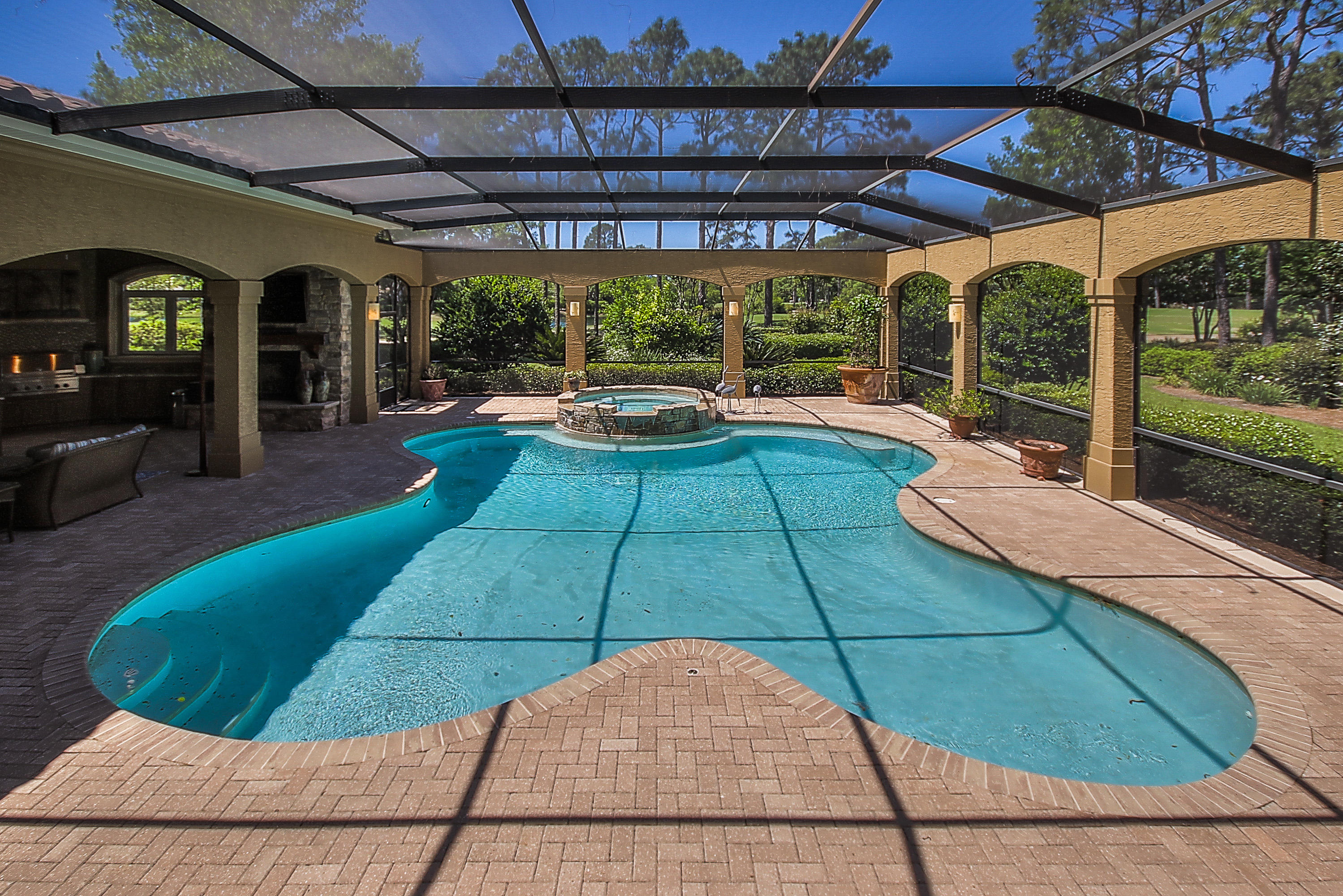 PRICE REDUCE $200,000 ''TODAY'' GREAT BUY $285/FOOT::: This Elegant Custom Master Home features 5 spacious bedrooms and 5 baths. A warm and inviting 2 story foyer greets you with views of the screened-in pool, lake and golf course. The Grande Salon is punctuated by soaring ceilings, impressive fireplace, walk in bar and a wall of glass windows and doors which provide for expansive pool and golf course views. The Kitchen and Family Room have walls made of a unique French limestone application, which is also used to help maintain a proper temperature in the wine cellar nestled beneath the curved, entry stairway. The kitchen features custom cabinetry, granite countertops, top of the line appliances, Kitchen Island with a breakfast bar and a creamy granite top, tile backsplash, woo