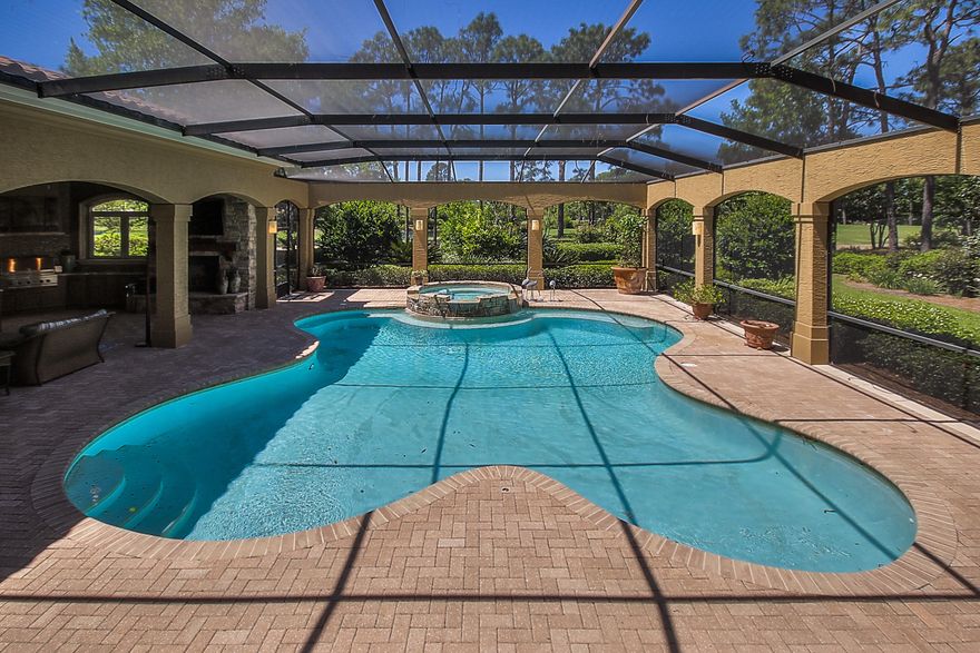 PRICE REDUCE $200,000 ''TODAY'' GREAT BUY $285/FOOT::: This Elegant Custom Master Home features 5 spacious bedrooms and 5 baths. A warm and inviting 2 story foyer greets you with views of the screened-in pool, lake and golf course. The Grande Salon is punctuated by soaring ceilings, impressive fireplace, walk in bar and a wall of glass windows and doors which provide for expansive pool and golf course views. The Kitchen and Family Room have walls made of a unique French limestone application, which is also used to help maintain a proper temperature in the wine cellar nestled beneath the curved, entry stairway. The kitchen features custom cabinetry, granite countertops, top of the line appliances, Kitchen Island with a breakfast bar and a creamy granite top, tile backsplash, woo