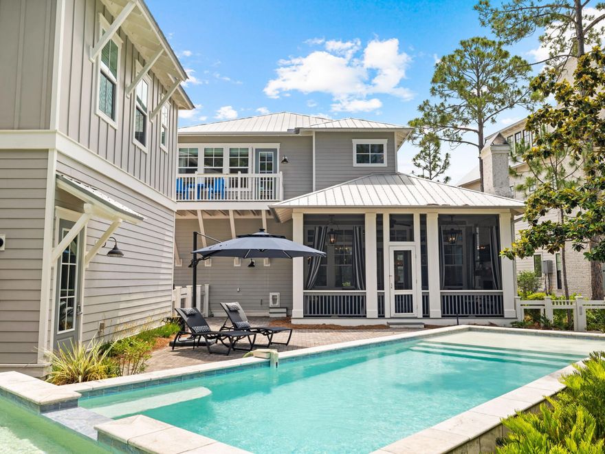 This stately WaterColor home with private pool and carriage house occupies one of the largest lots in the community. Decorative rain-chain downspouts and full-width porches create instant curb appeal. Professionally decorated throughout, the first floor has shiplap walls, neutral furnishings and mellow hardwood flooring. The light, open family room is perfect for family gatherings and entertaining with a more intimate sitting area around the feature fireplace. Keen cooks will appreciate the gourmet kitchen, which is fully equipped with Sub-Zero and Wolf appliances, including a double oven. White cabinets and a large pantry store everything neatly out of sight. Marble countertops add a sophisticated finish to the large island with its high-top bar.