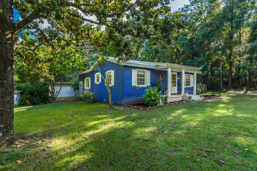 Adorable Remodeled cottage home on almost an acre!! Land includes a second parcel that can be divided out to build later.  Gorgeous slice of country paradise right in the heart of town!  Brand new Kitchen wows with granite counters, stainless appliances and tiled backsplash.  Home has real hardware floors underneath the LVP that is laid, as well as tongue and groove wood ceilings underneath the decorative ceiling panels-so there is still room to make it yours!  Open kitchen and dining, spacious baths and large closets!  Relax in the enclosed sun room, sit out at your own firepit, and enjoy country living 1 minute from grocerys and stores!  A/C 2021, Metal roof